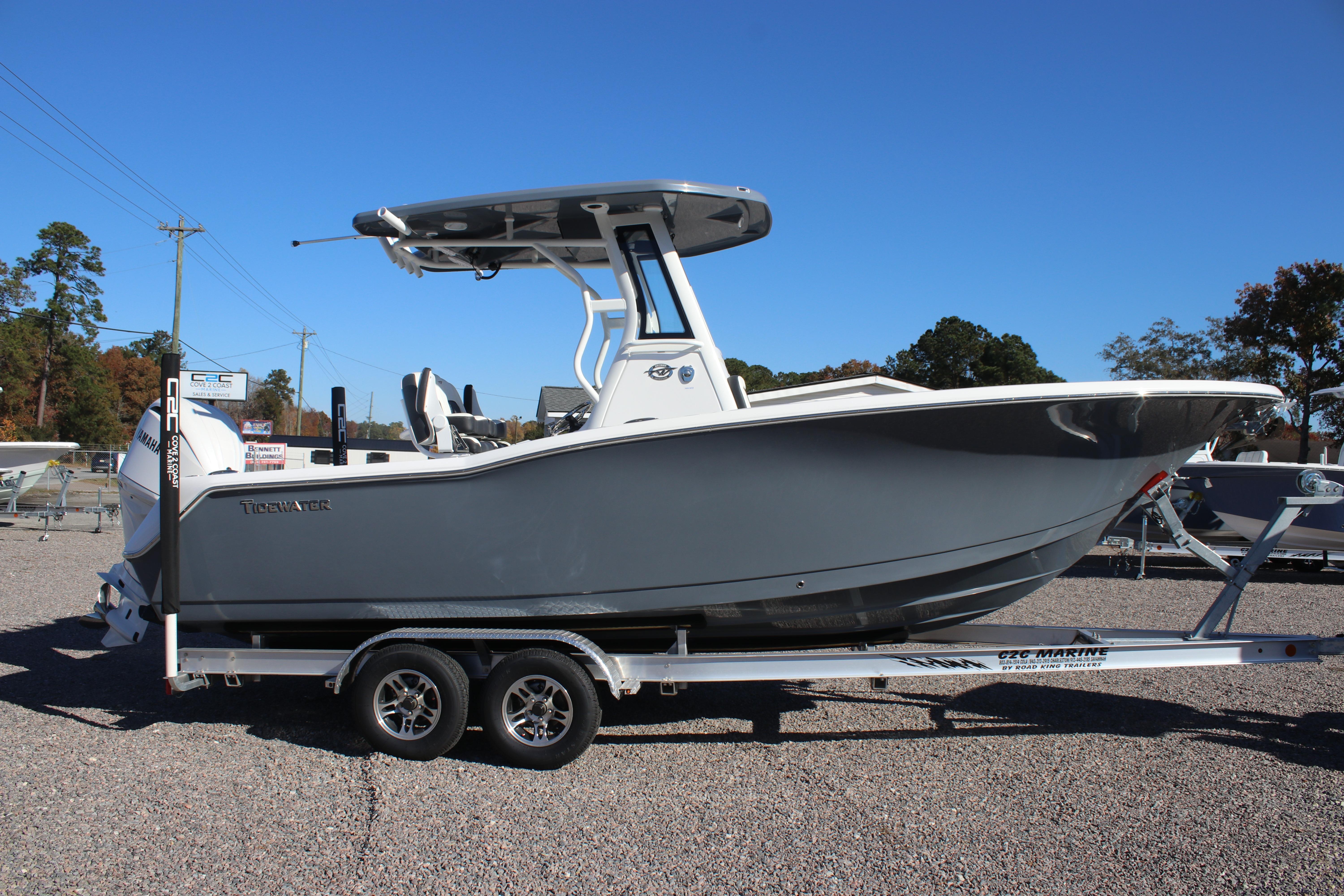 2026 Tidewater 232 CC Adventure boat on trailer, side view, outdoors.