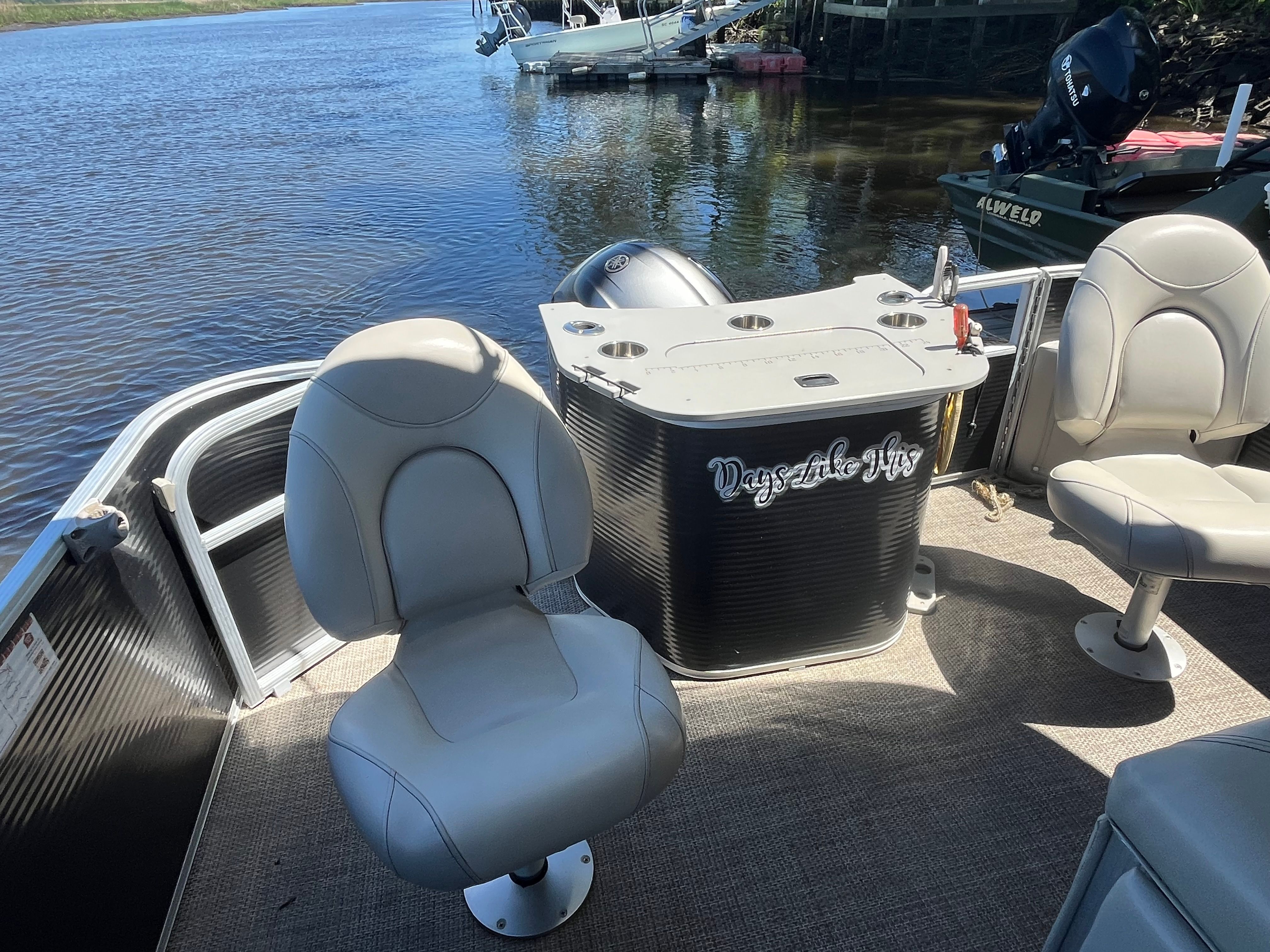 The image shows the cockpit of a 2019 Bennington 23 SX pontoon boat with comfortable seating.