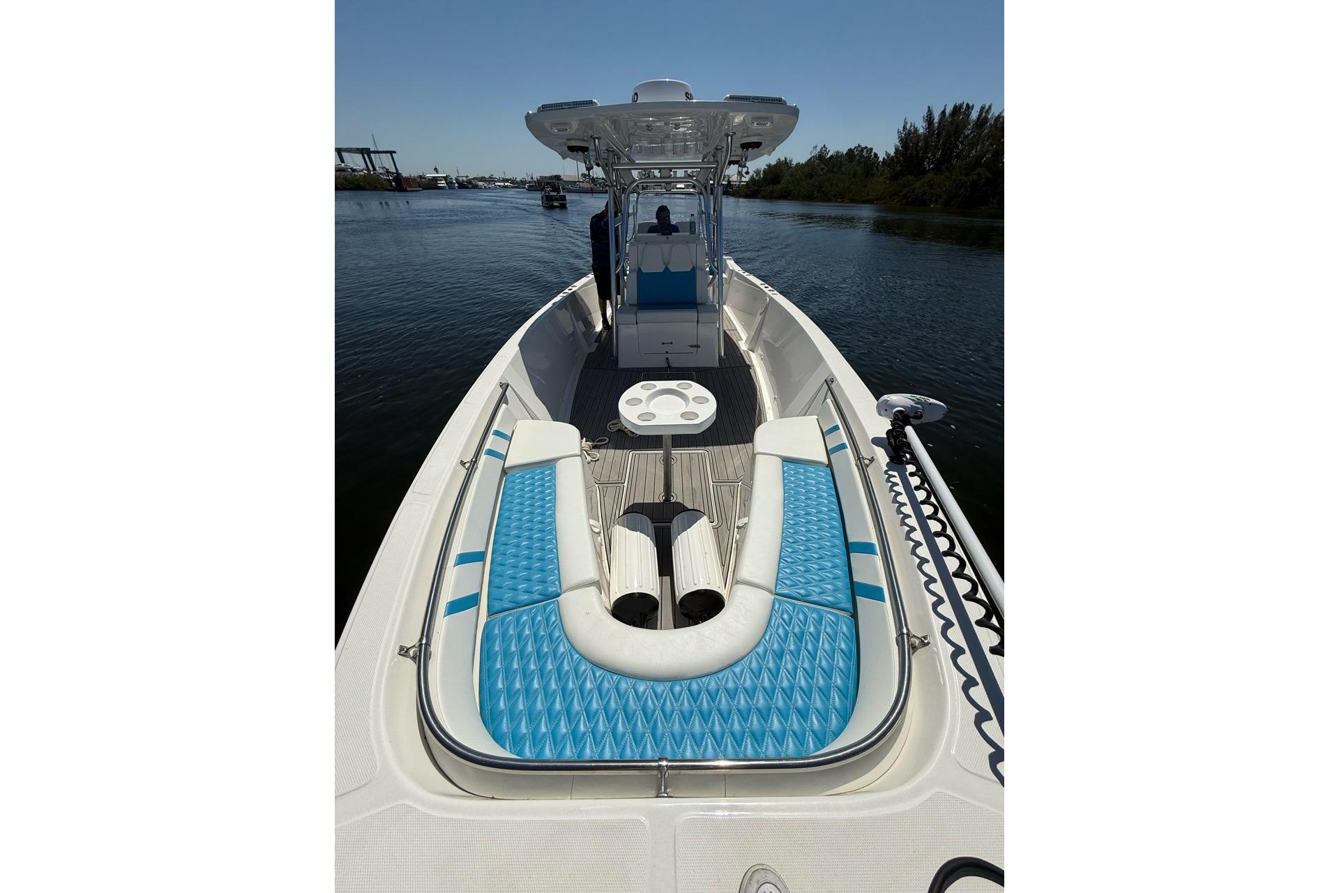 2021 Custom Infusion 34 CC boat with blue seating on calm water.