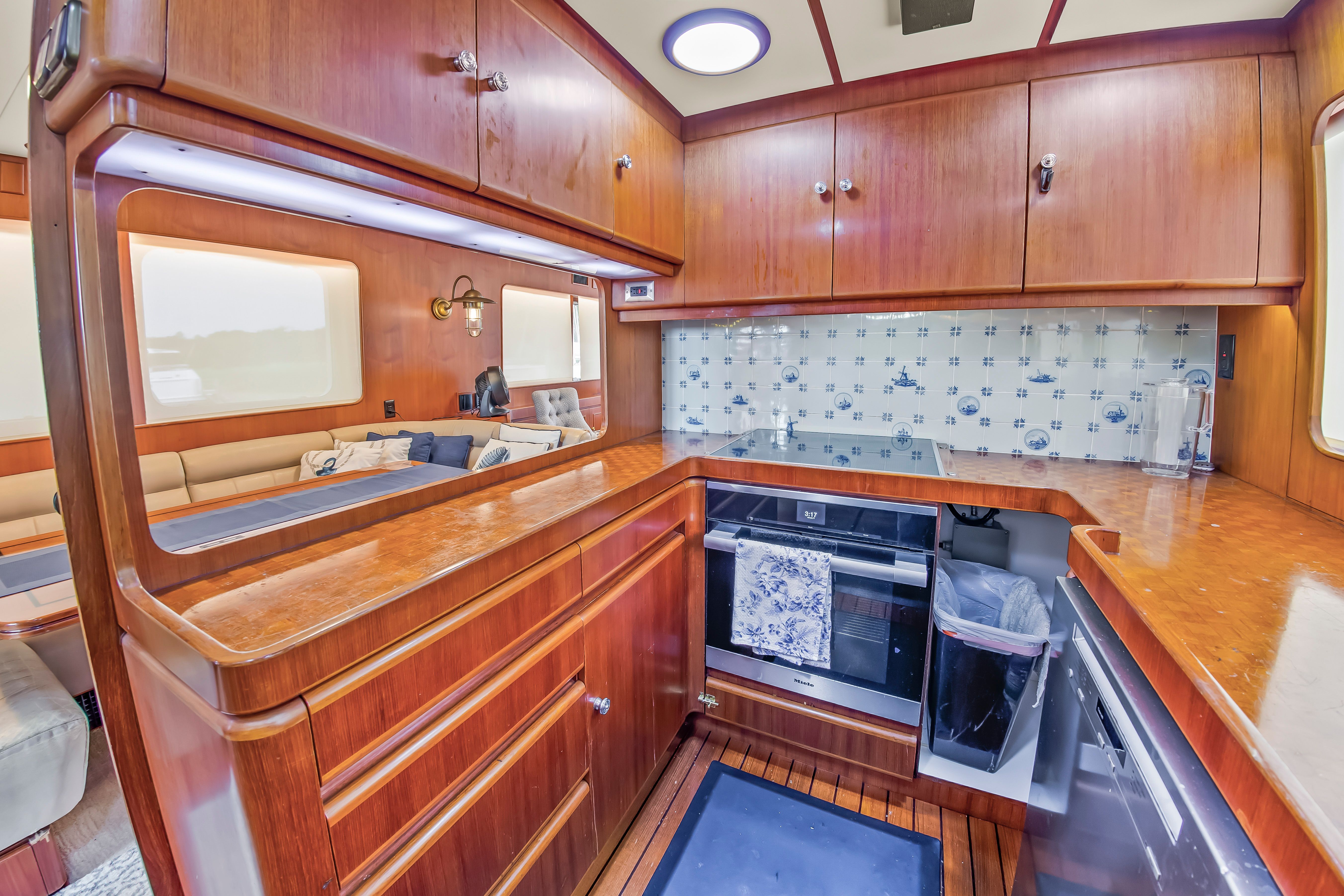 The 1987 Jongert 78 Motor Yacht's kitchen features wooden cabinets and modern appliances.