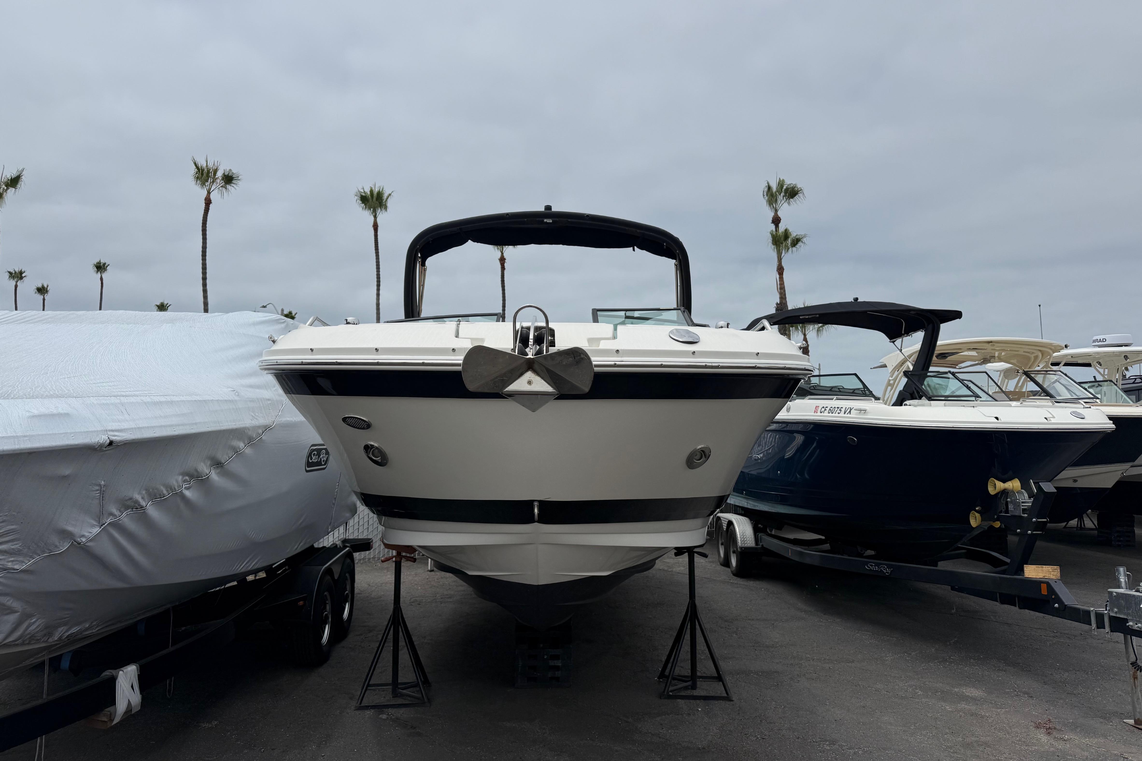 2022 Sea Ray SDX 290 Outboard boat displayed in a marina with palm trees.