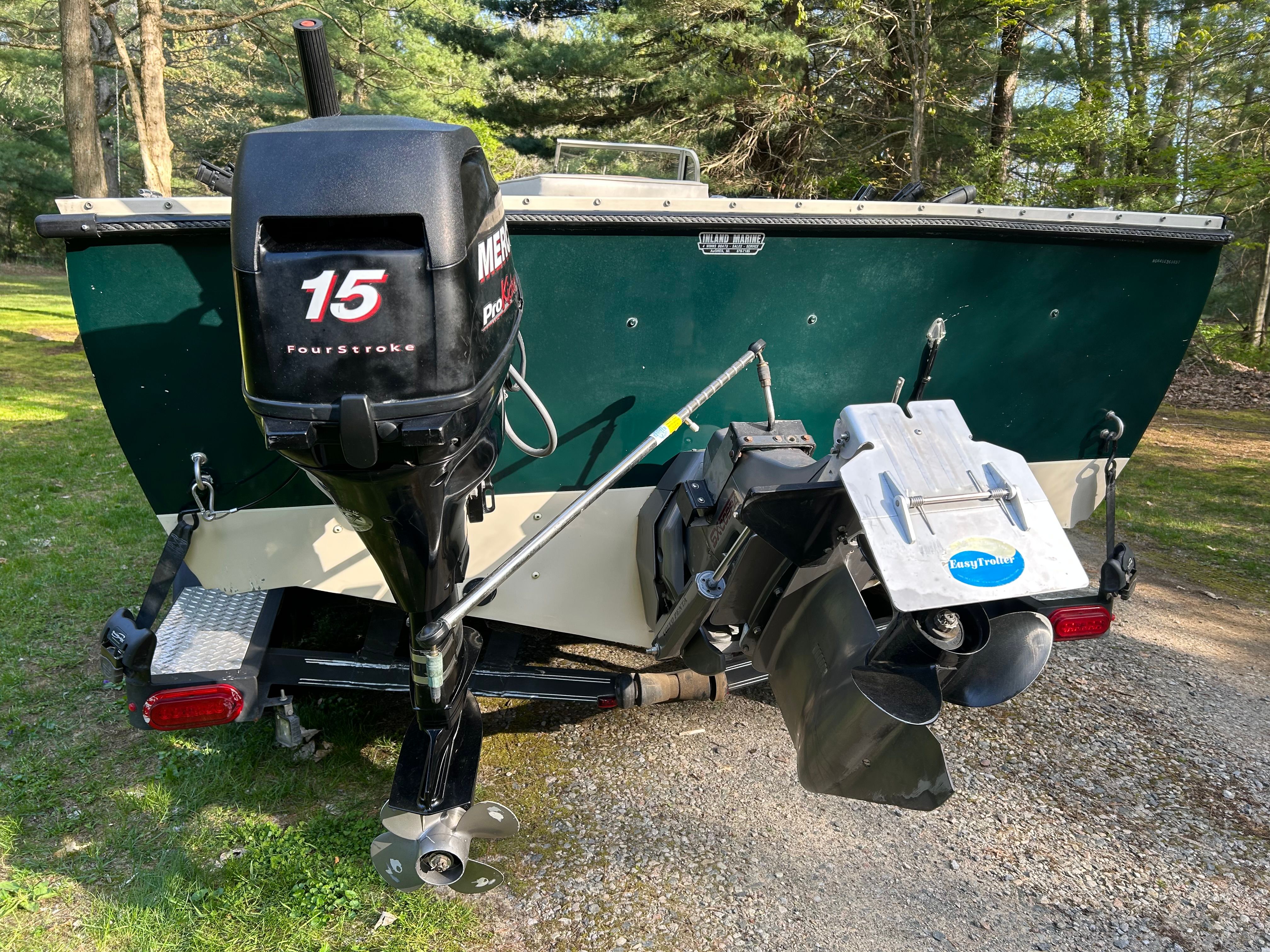 Rear view of a 1997 Crestliner 2050 Sportfish with outboard motor.
