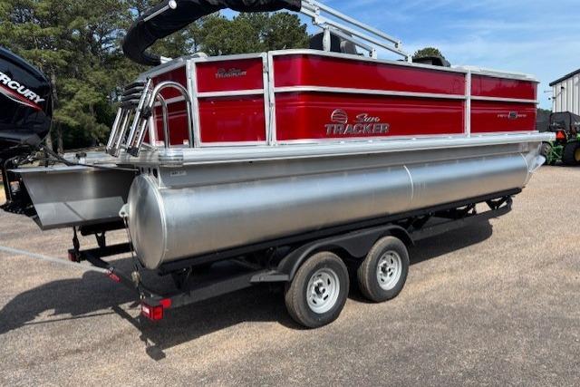 2026 Sun Tracker Party Barge 20 DLX pontoon boat on trailer, red and silver design.