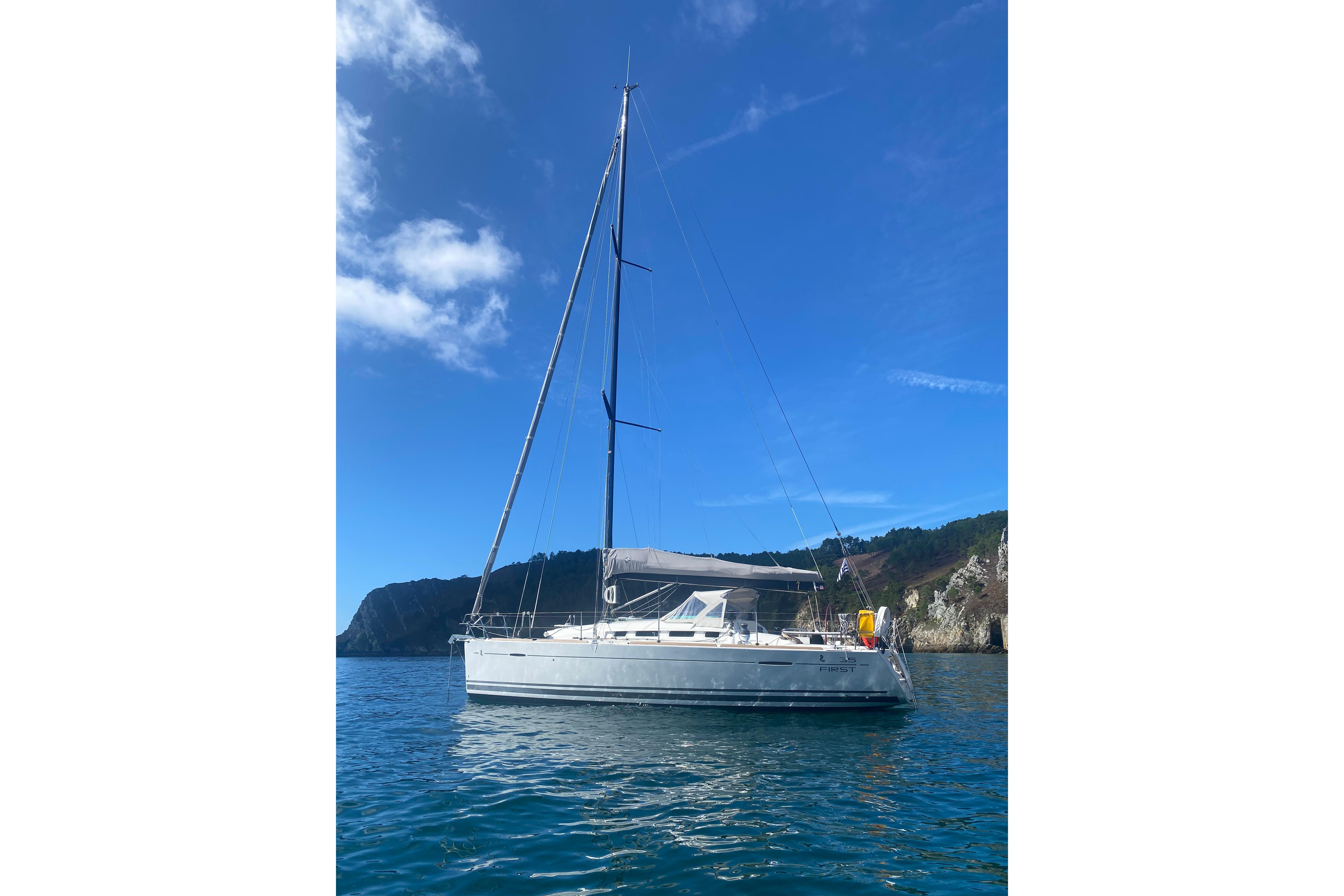 Sailing yacht Beneteau First 35, 2011 model, anchored in scenic coastal waters.