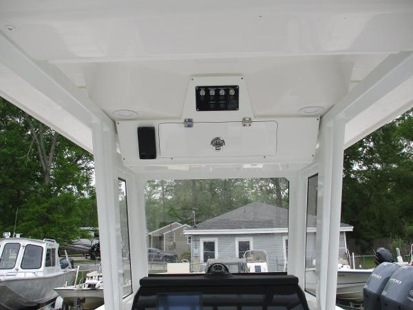 2025 Sea Fox 228 Commander boat interior, featuring control panel and overhead storage.