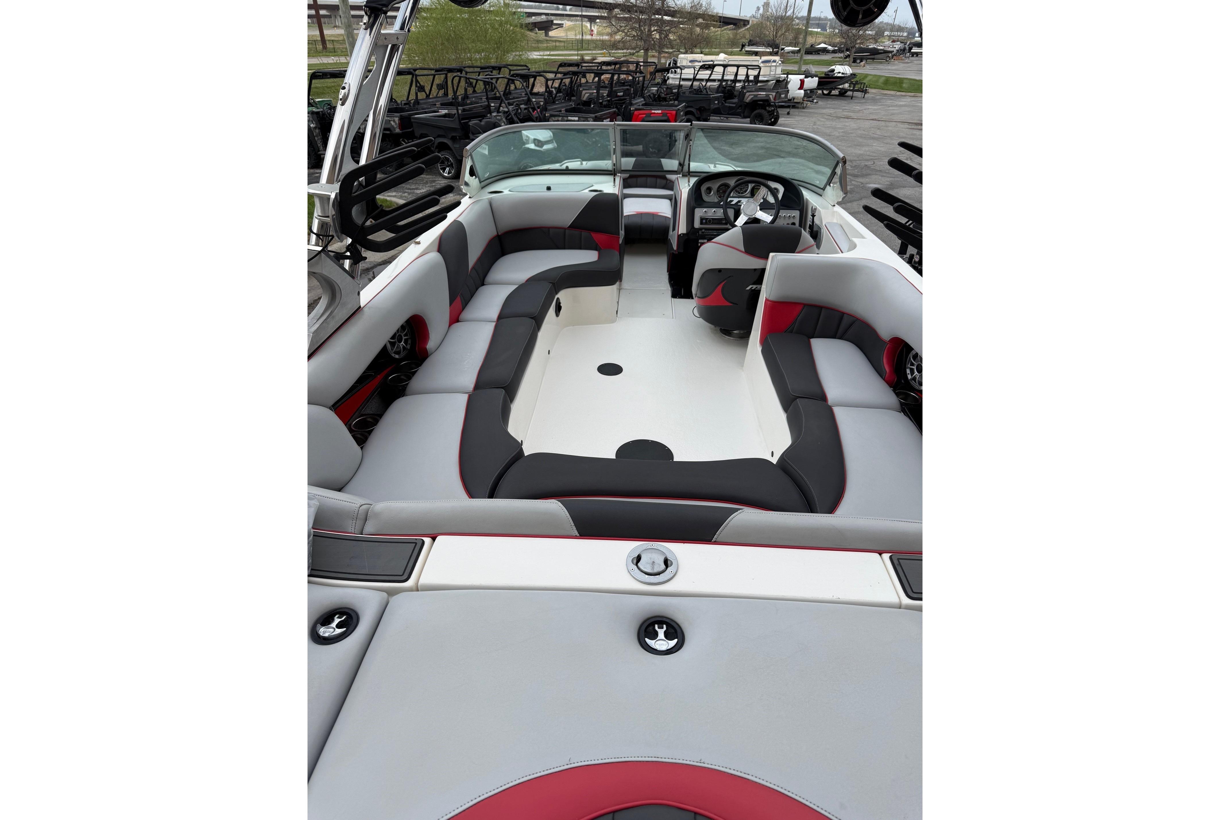 2014 MBSPORTS B523 23V boat interior with gray and red seating, steering wheel, and dashboard.