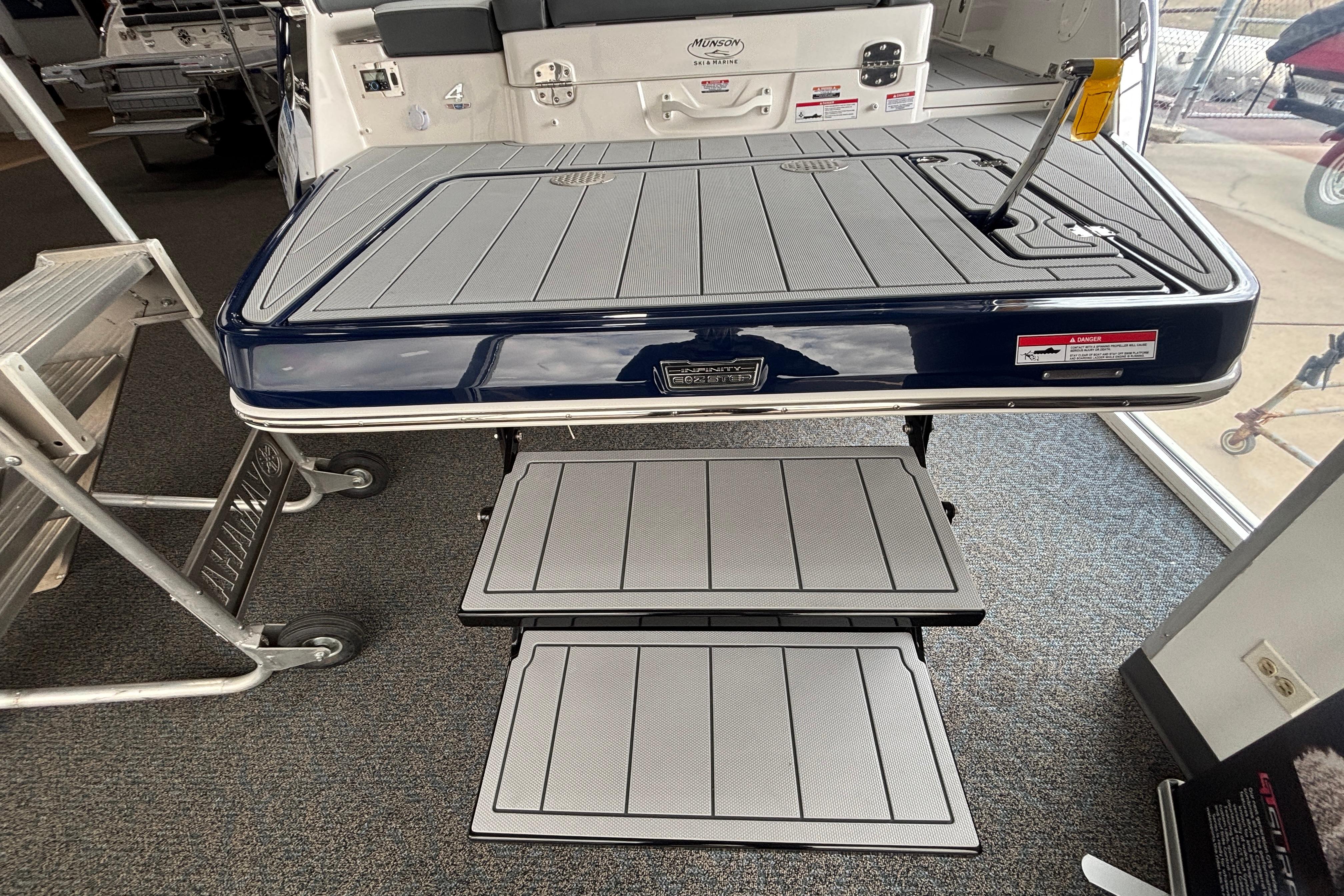 2026 Chaparral SSX 4 boat swim platform with foldable steps in showroom.