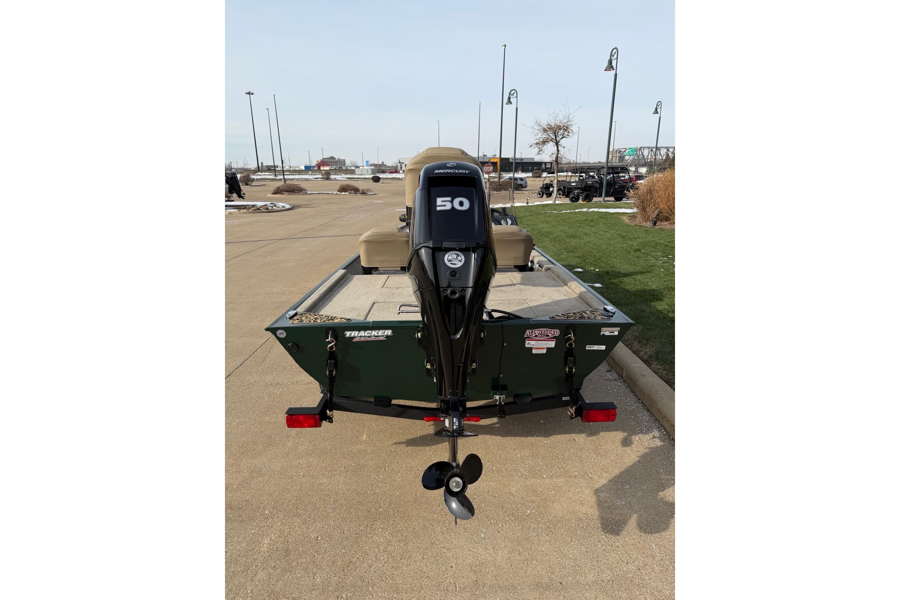 2026 Tracker Bass Tracker Classic Limited boat with 50 HP motor, parked outdoors.