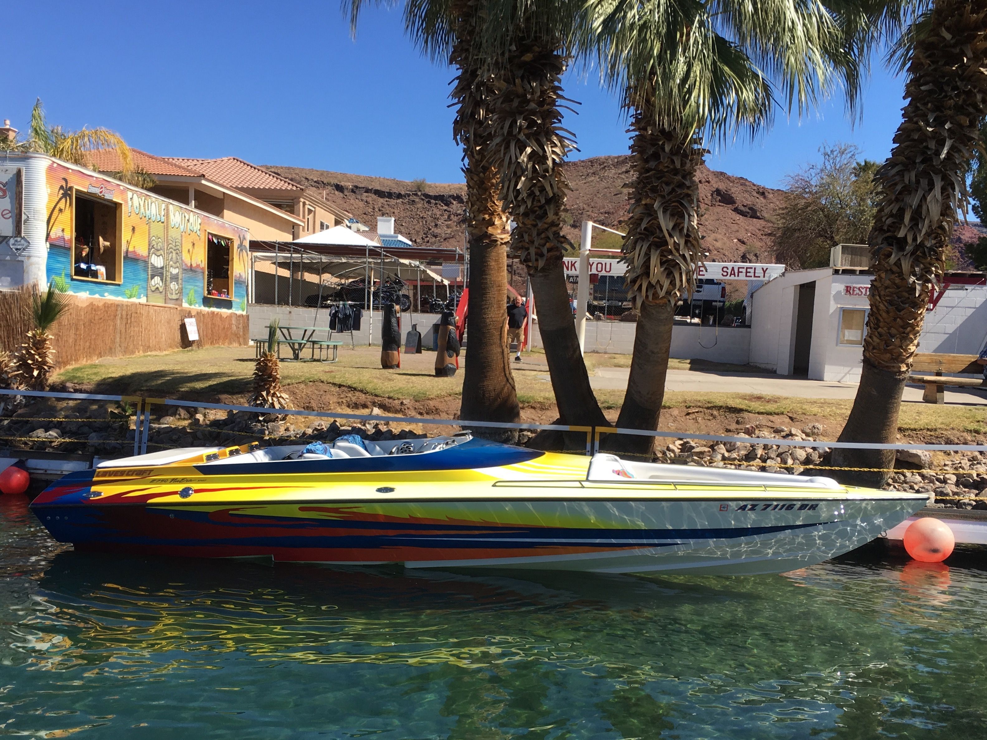 2002 Lavey Craft 2750 NUERA boat on water, palm trees in background.