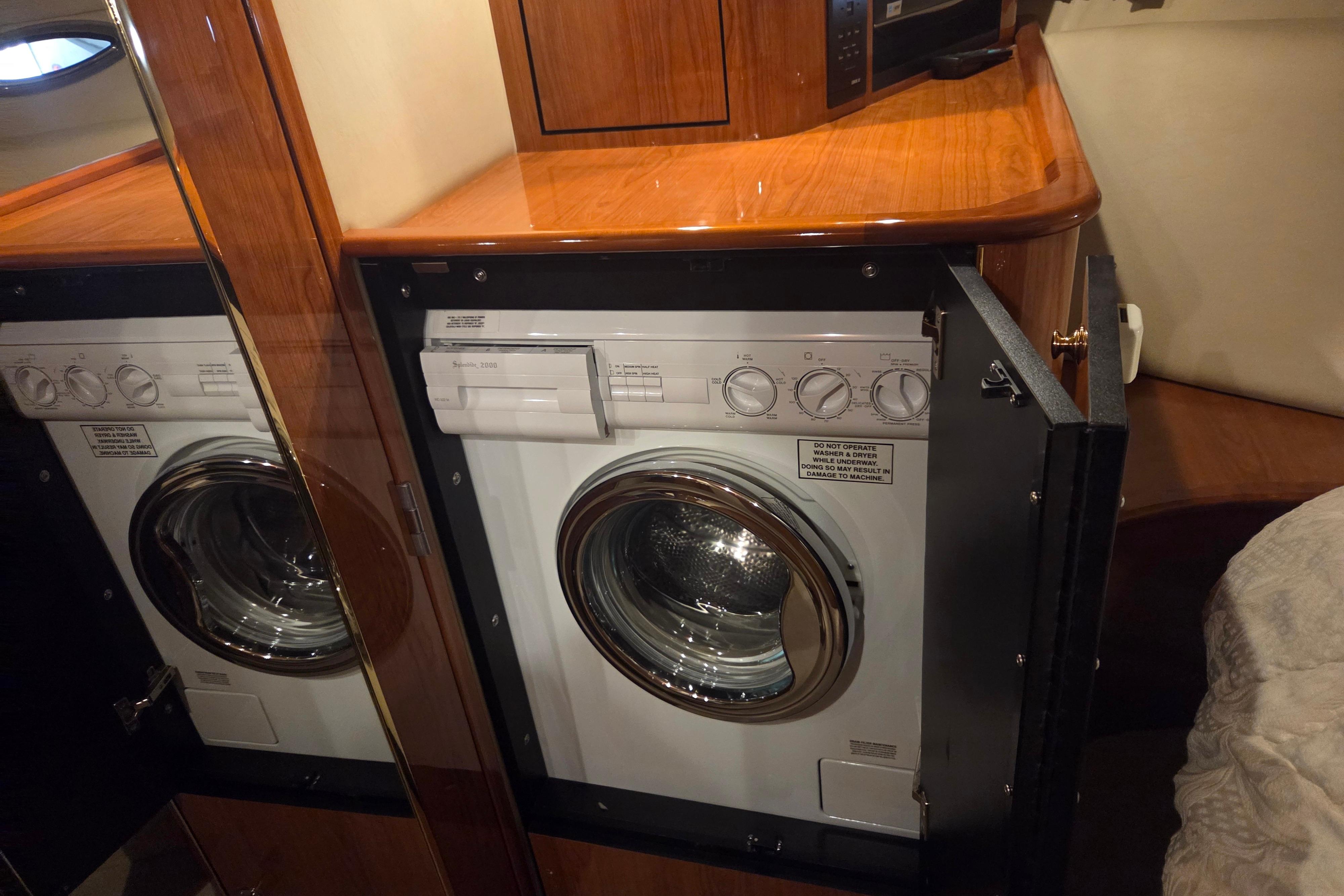 Laundry area inside a 2000 Sea Ray Sundancer 540 yacht, featuring a compact washing machine.