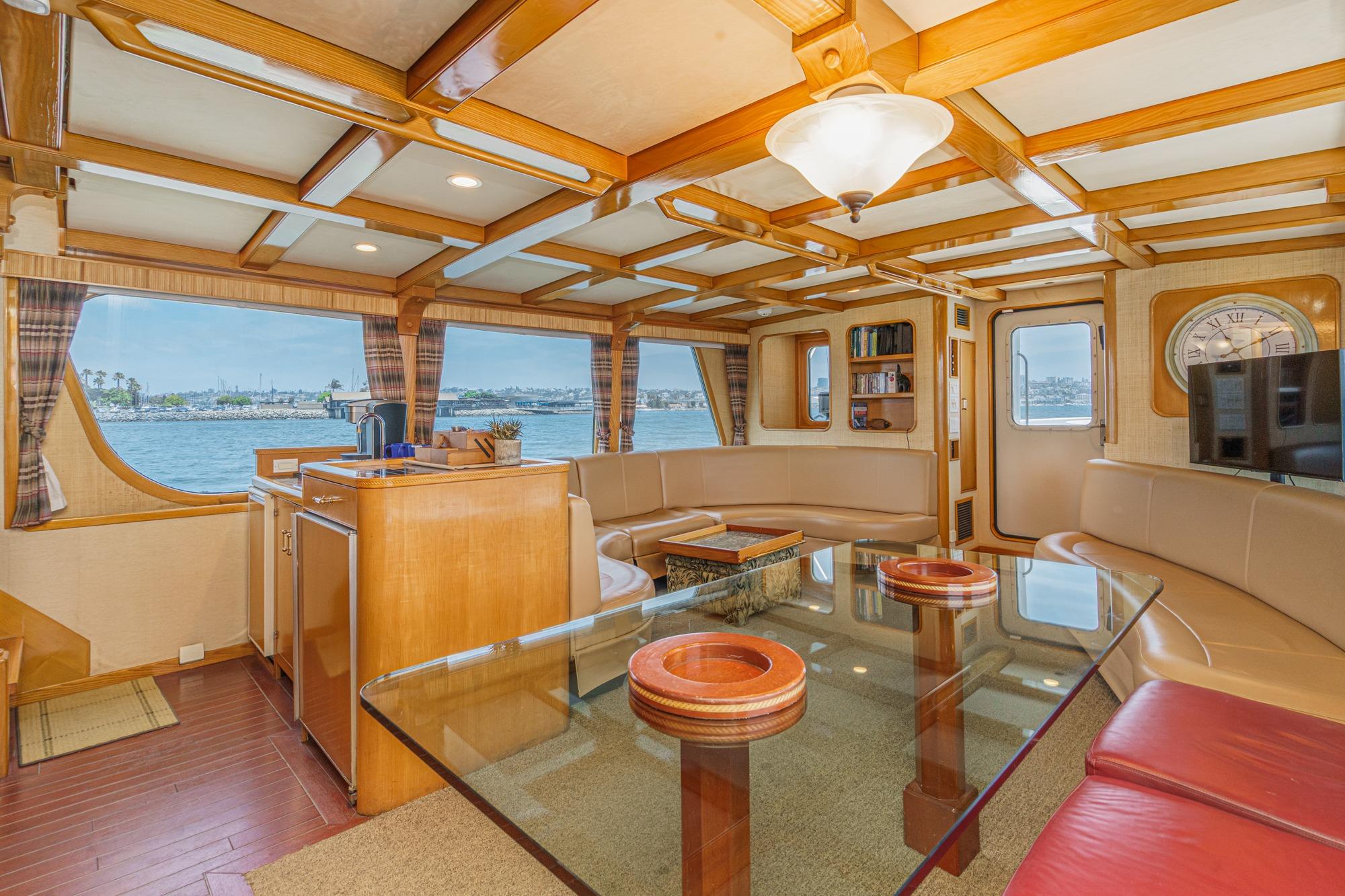 Luxurious interior of a 1990 Seaton Long Range Cruiser with panoramic windows and elegant furnishings.