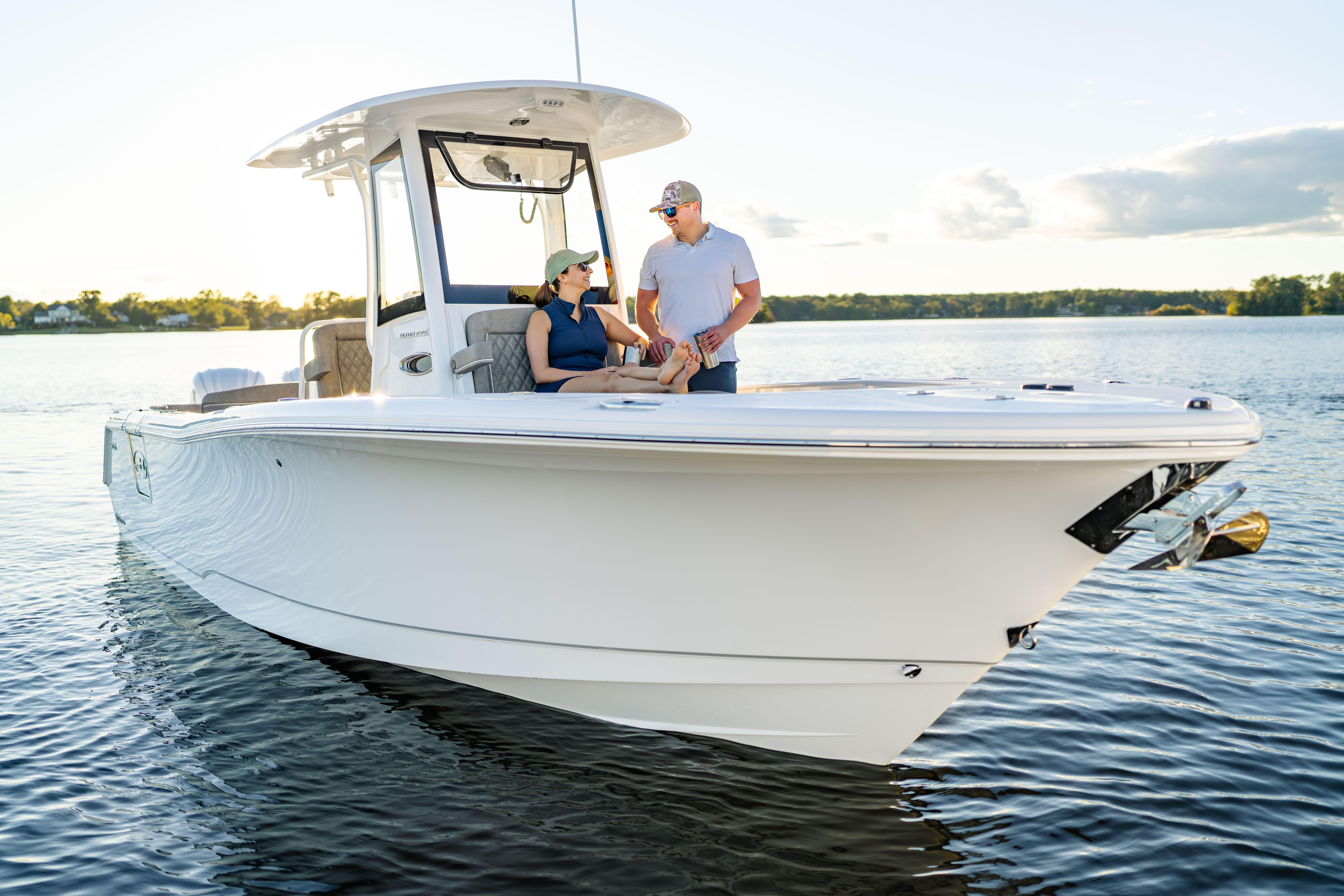 2026 Sea Hunt Ultra 275 Coffin Box boat on calm water with two people onboard.
