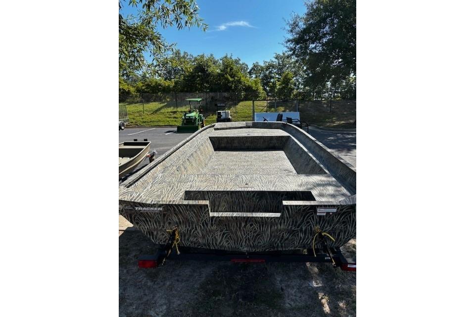 2026 Tracker Grizzly 2072 Utility boat with camouflage design, parked outdoors.