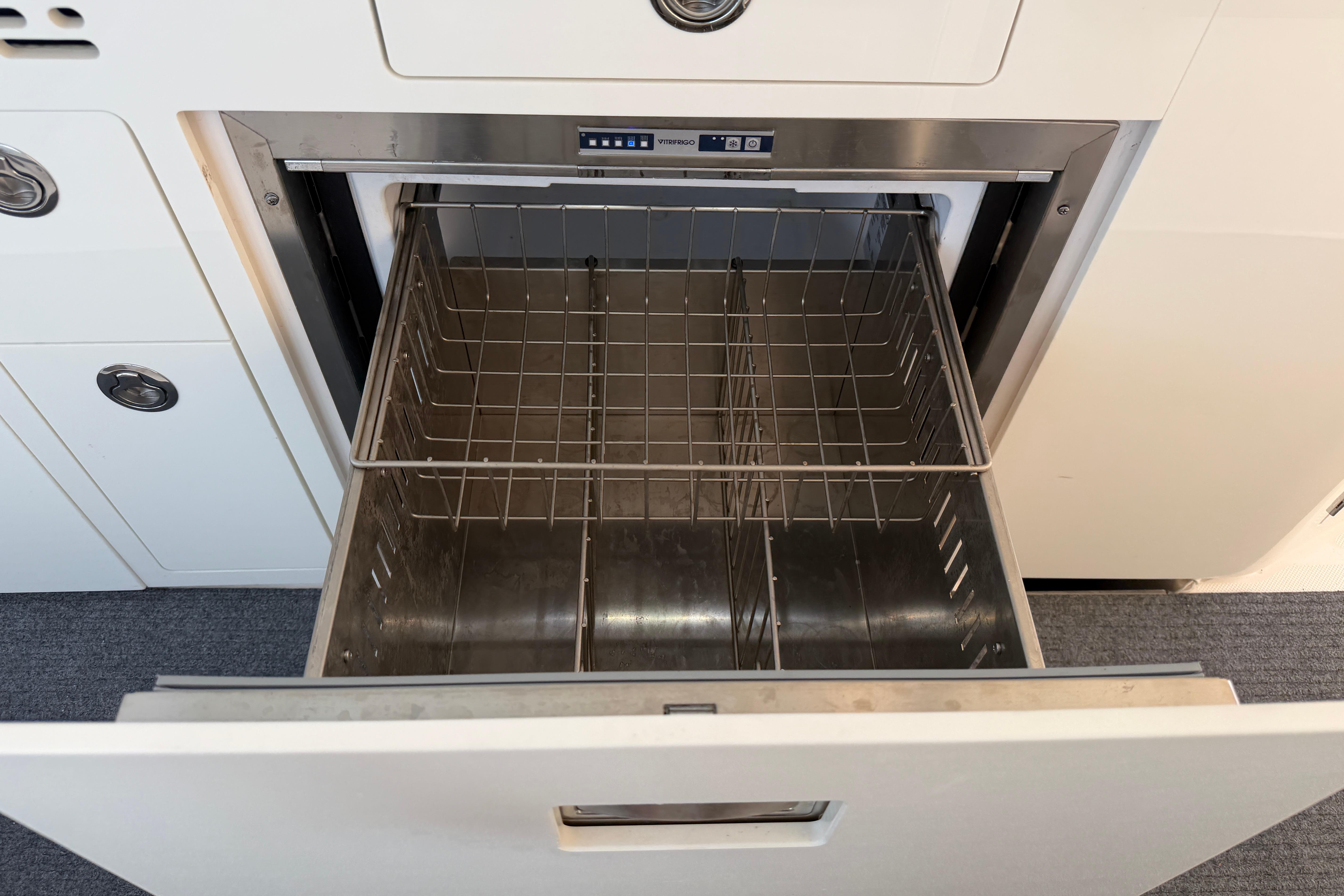 Open drawer on 2024 Regal 36 XO yacht, showcasing stainless steel interior.