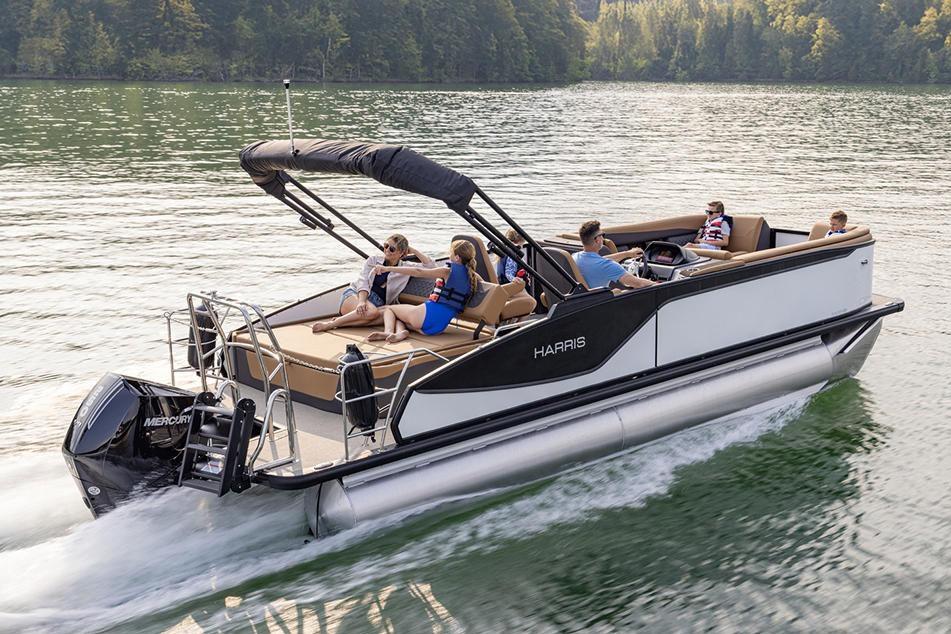 Manufacturer Provided Image: 2026 Harris Sunliner 250 pontoon boat cruising on a scenic lake with passengers.