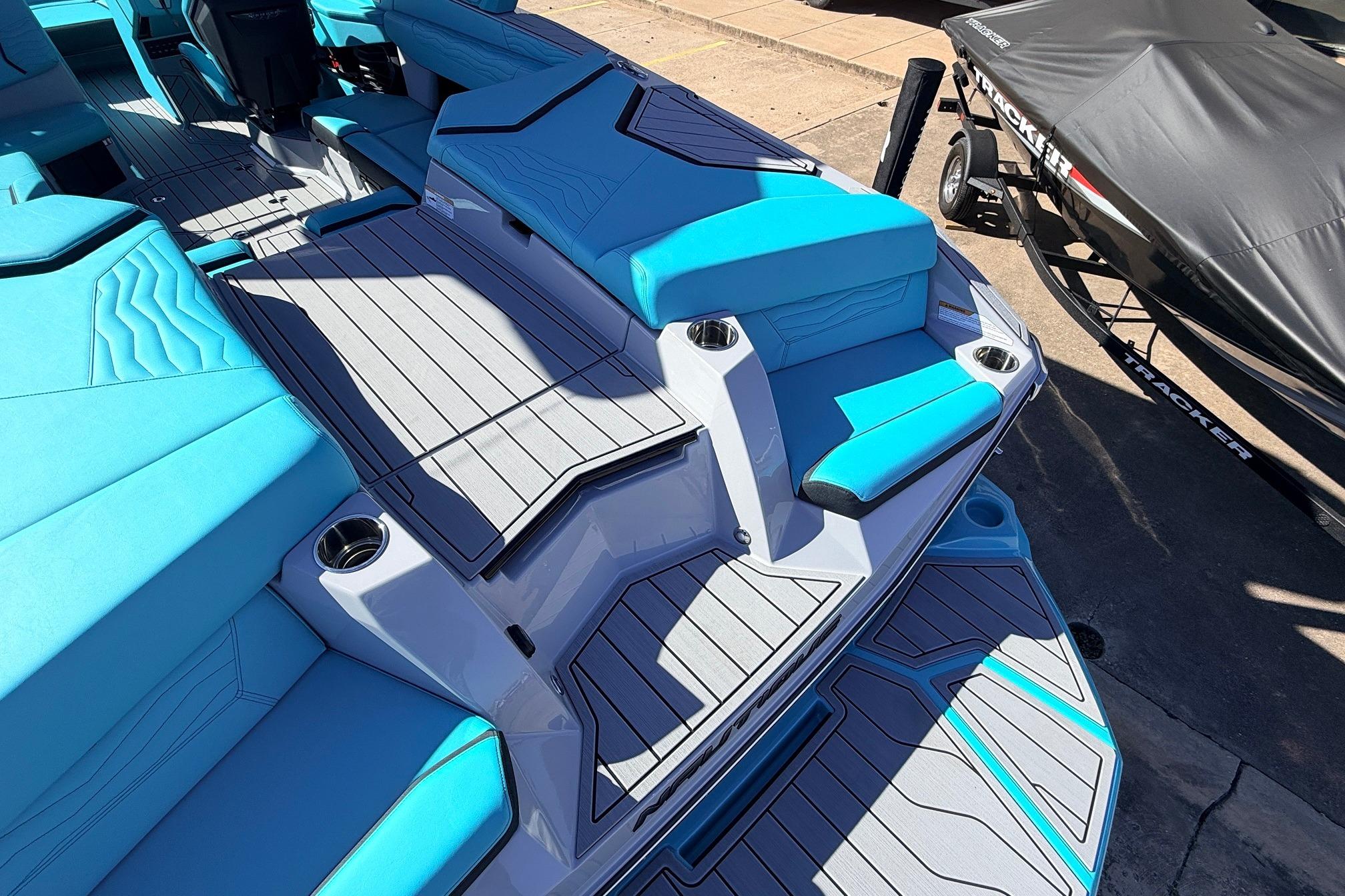 2026 Nautique Super Air Nautique G23 boat interior with blue seating and gray flooring.