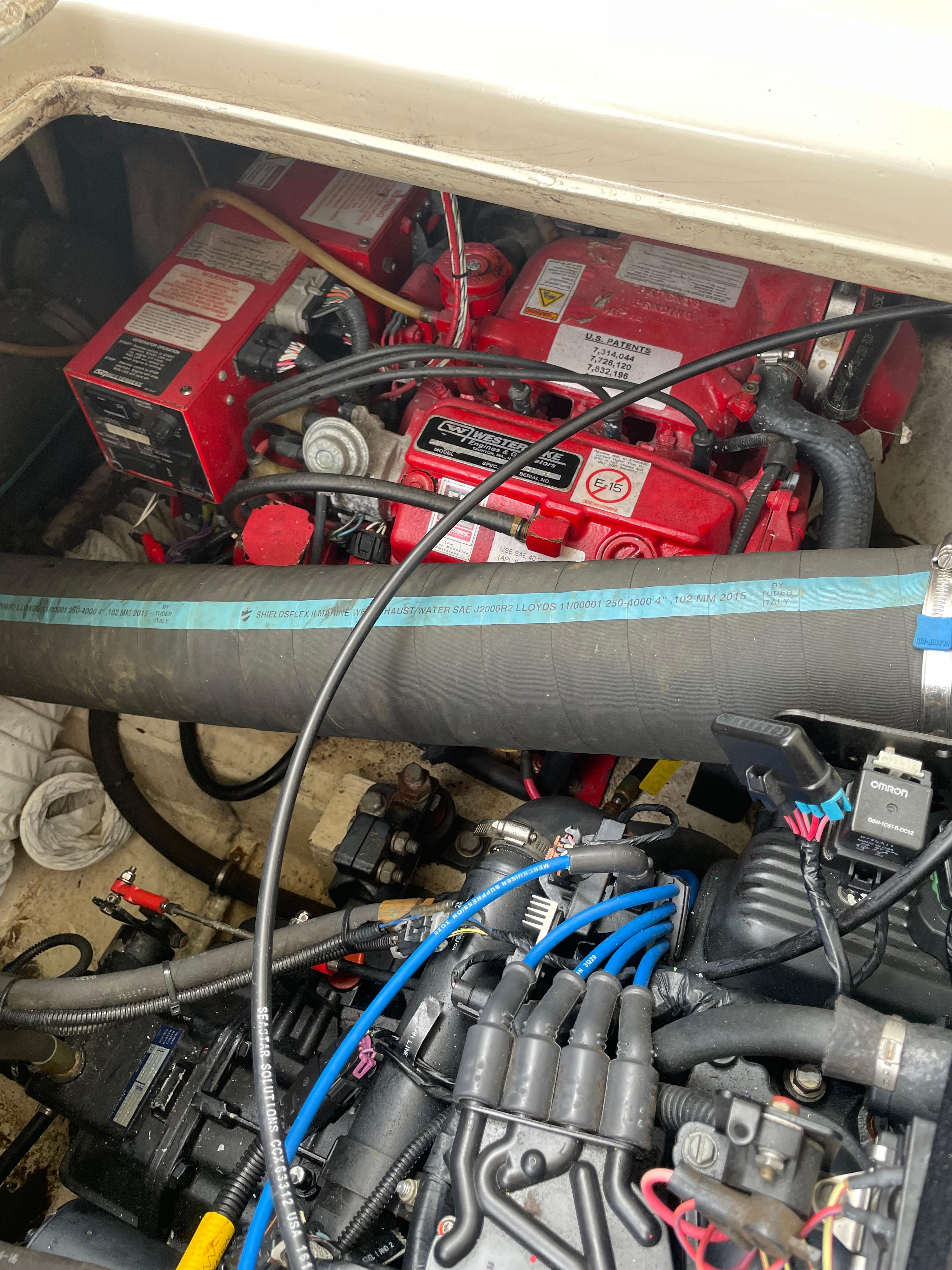 Engine compartment of 1967 Hatteras 28 Cruiser with visible red components and wiring.