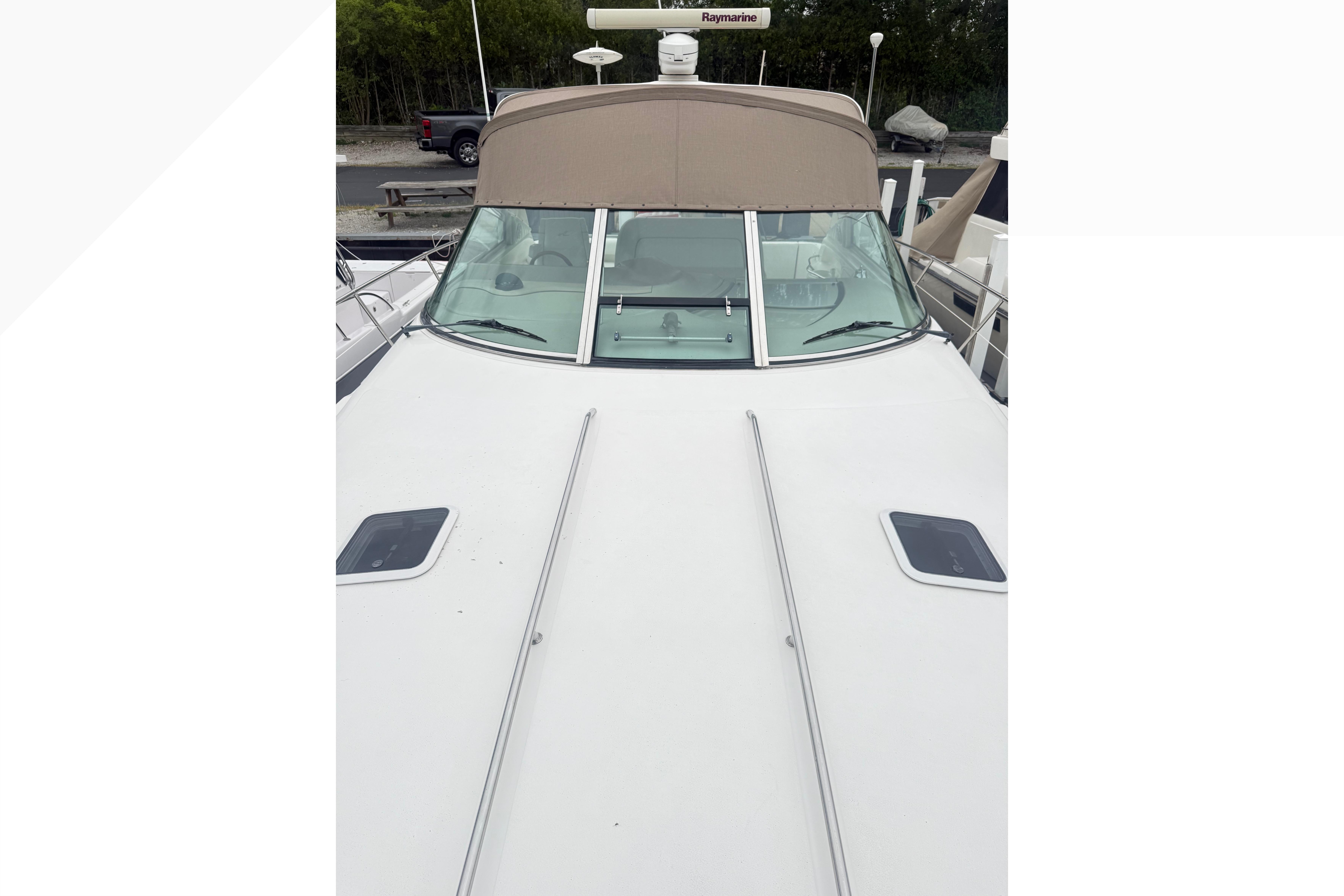1998 Sea Ray Sundancer 400 yacht with sleek white deck and tinted windshield.