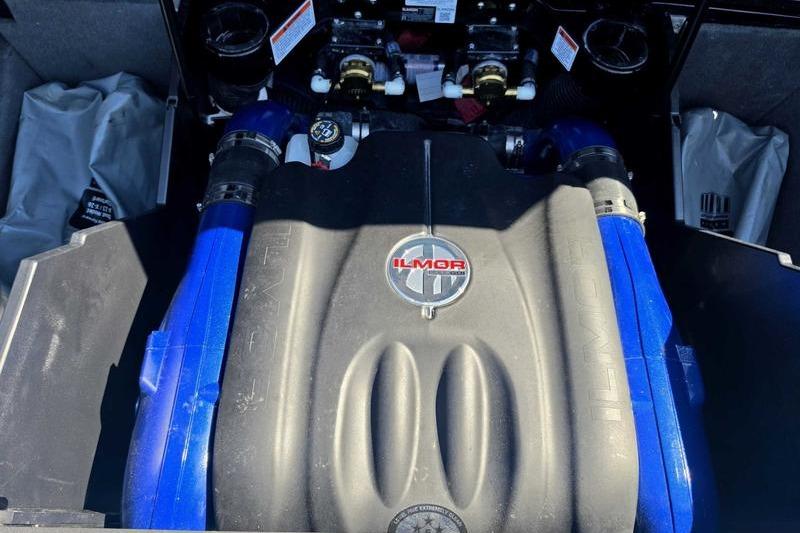 2017 MasterCraft X23 Ilmor engine with blue accents in a boat compartment.