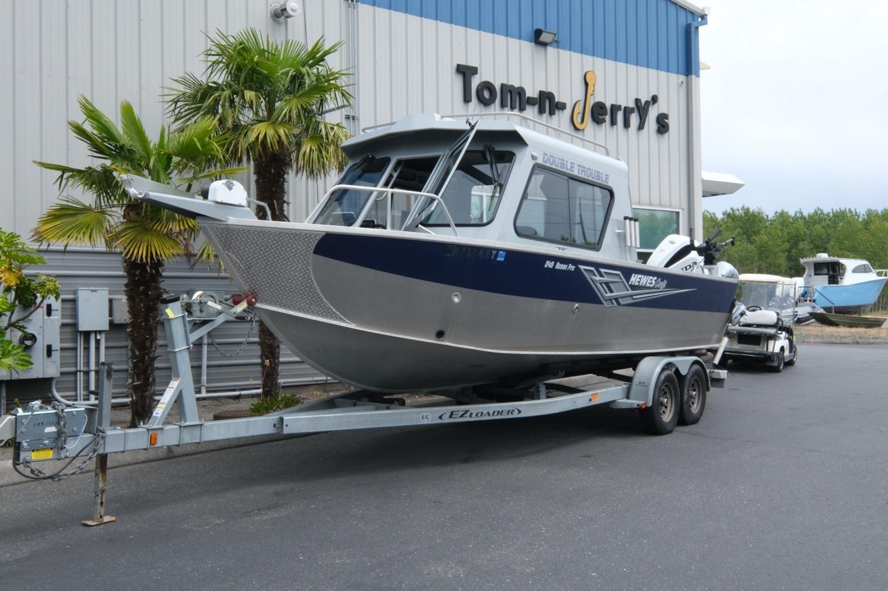 2021 Hewescraft 240 Ocean Pro ET Hardtop boat on trailer outside dealership.