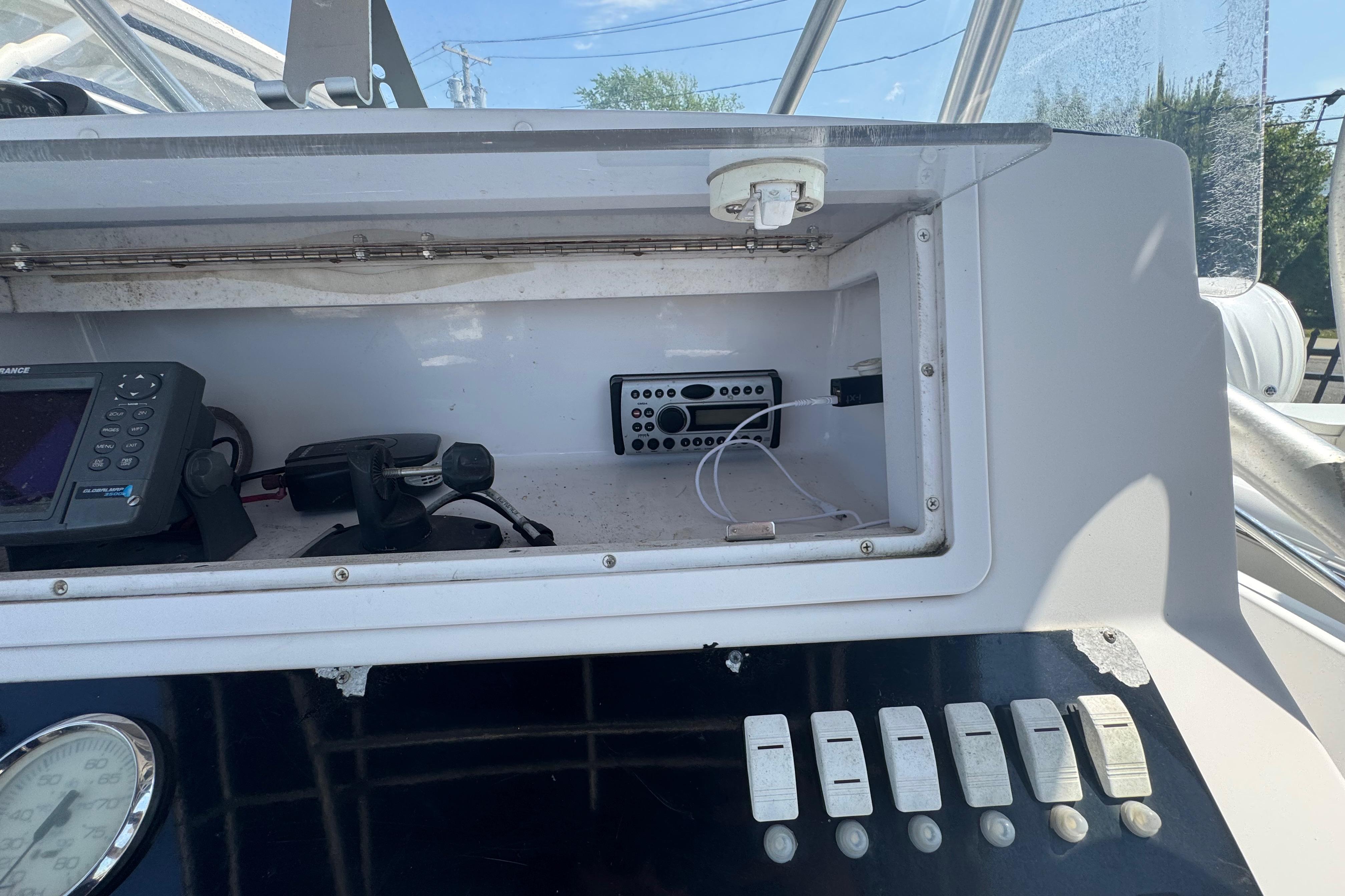 2002 Pro-Line 23 Sport boat dashboard with electronics and control switches.