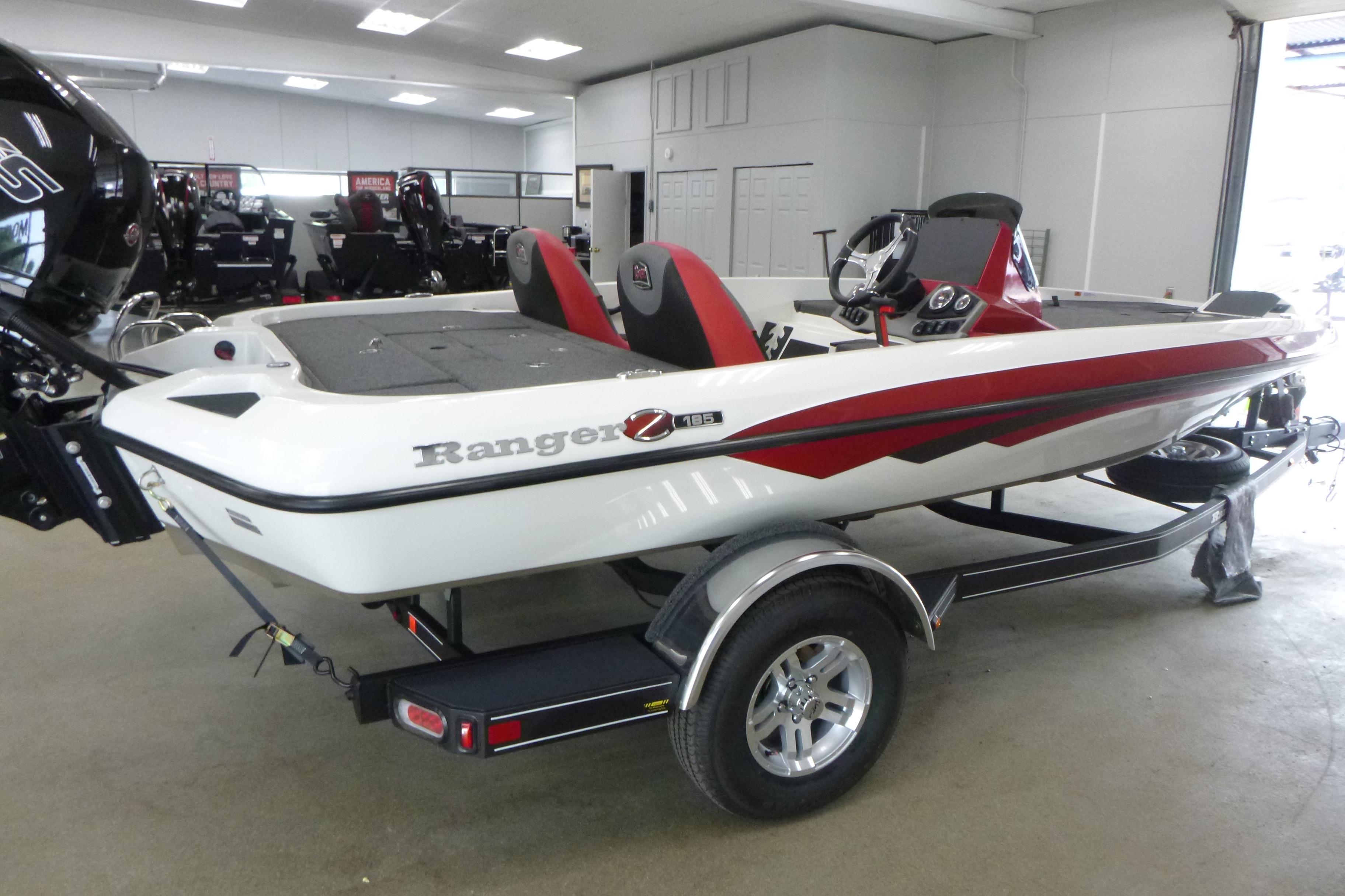 2025 Ranger Z185 boat with red accents on a trailer in a showroom.