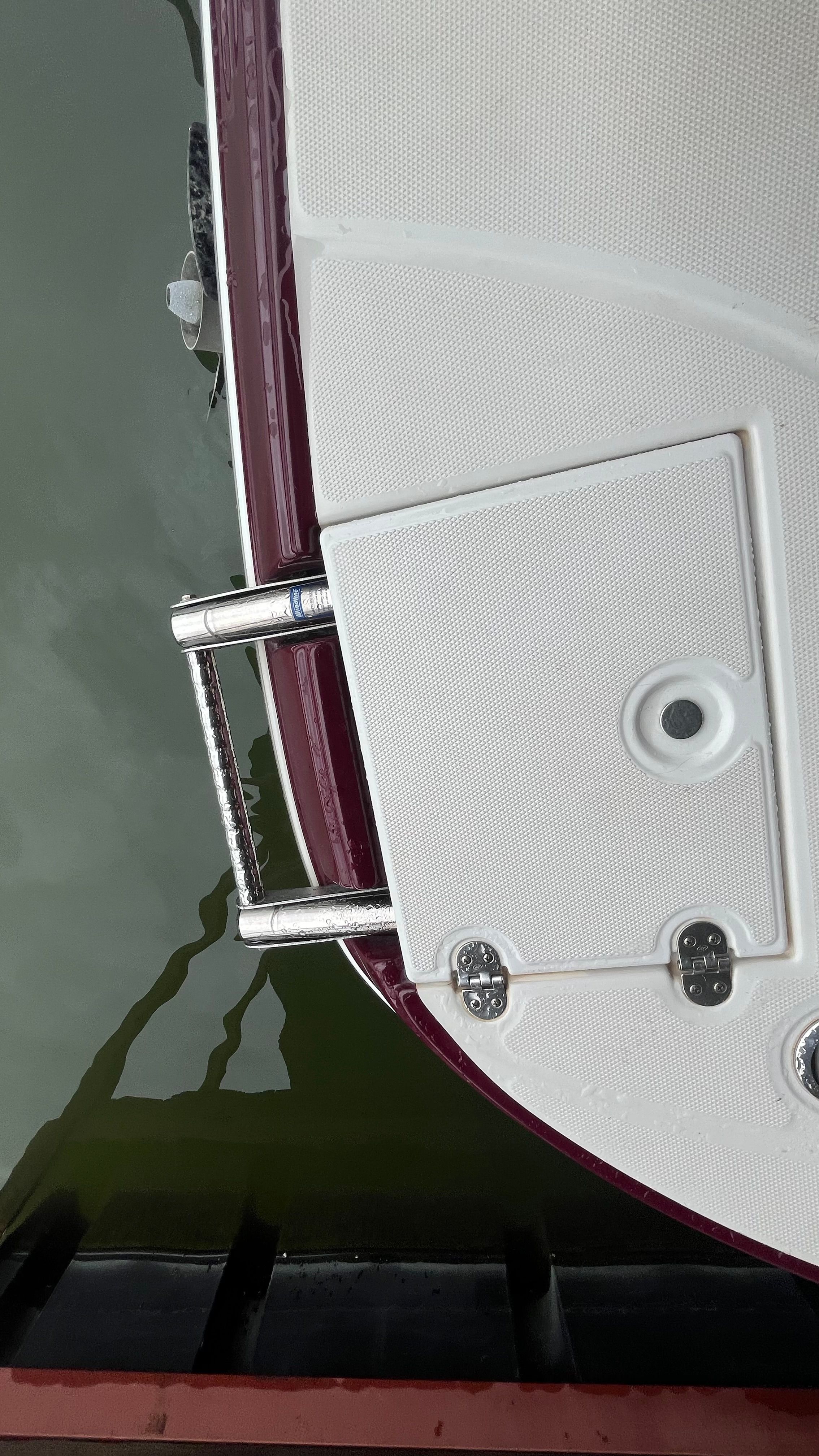 Close-up of a swim platform with a ladder on a boat.