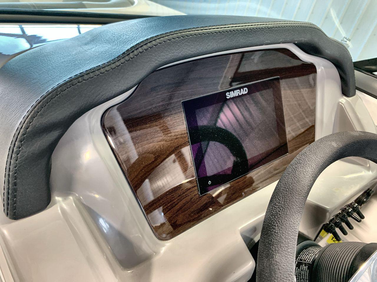 2025 Chaparral 21 SSi dashboard with Simrad display and leather trim.