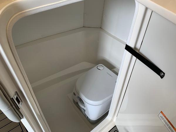 Portable toilet inside 2025 Sea Ray SPX 230 boat compartment.