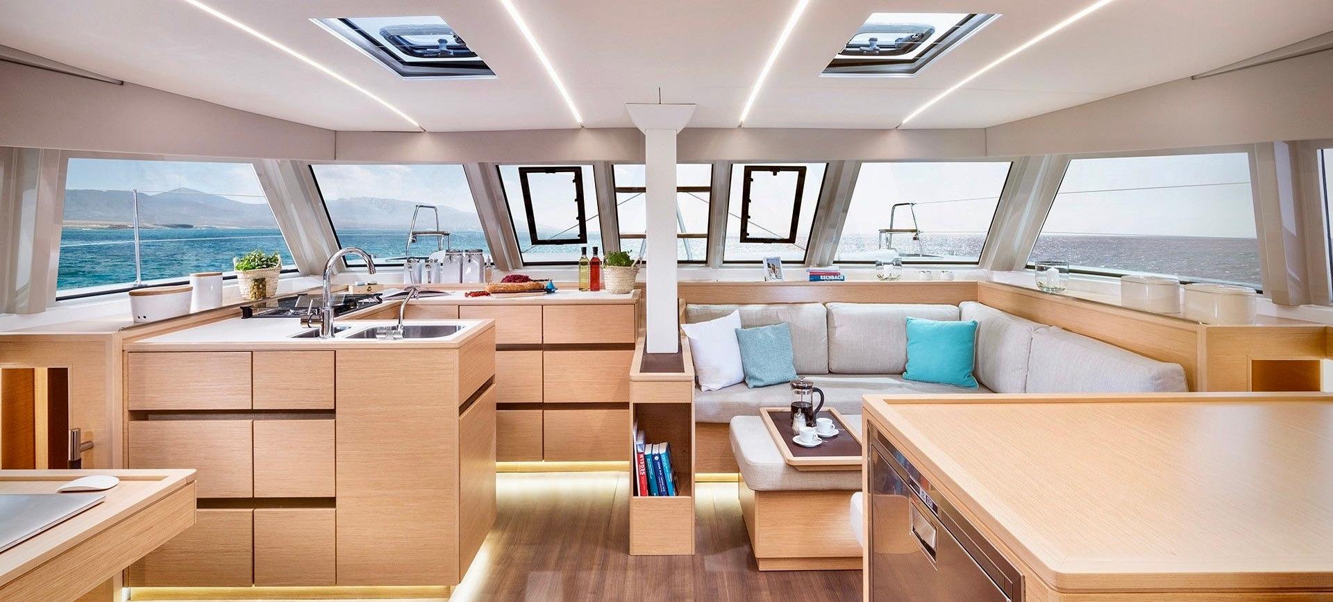 Luxurious interior of 2019 Bavaria Nautitech 46 FLY catamaran with modern kitchen and seating area.