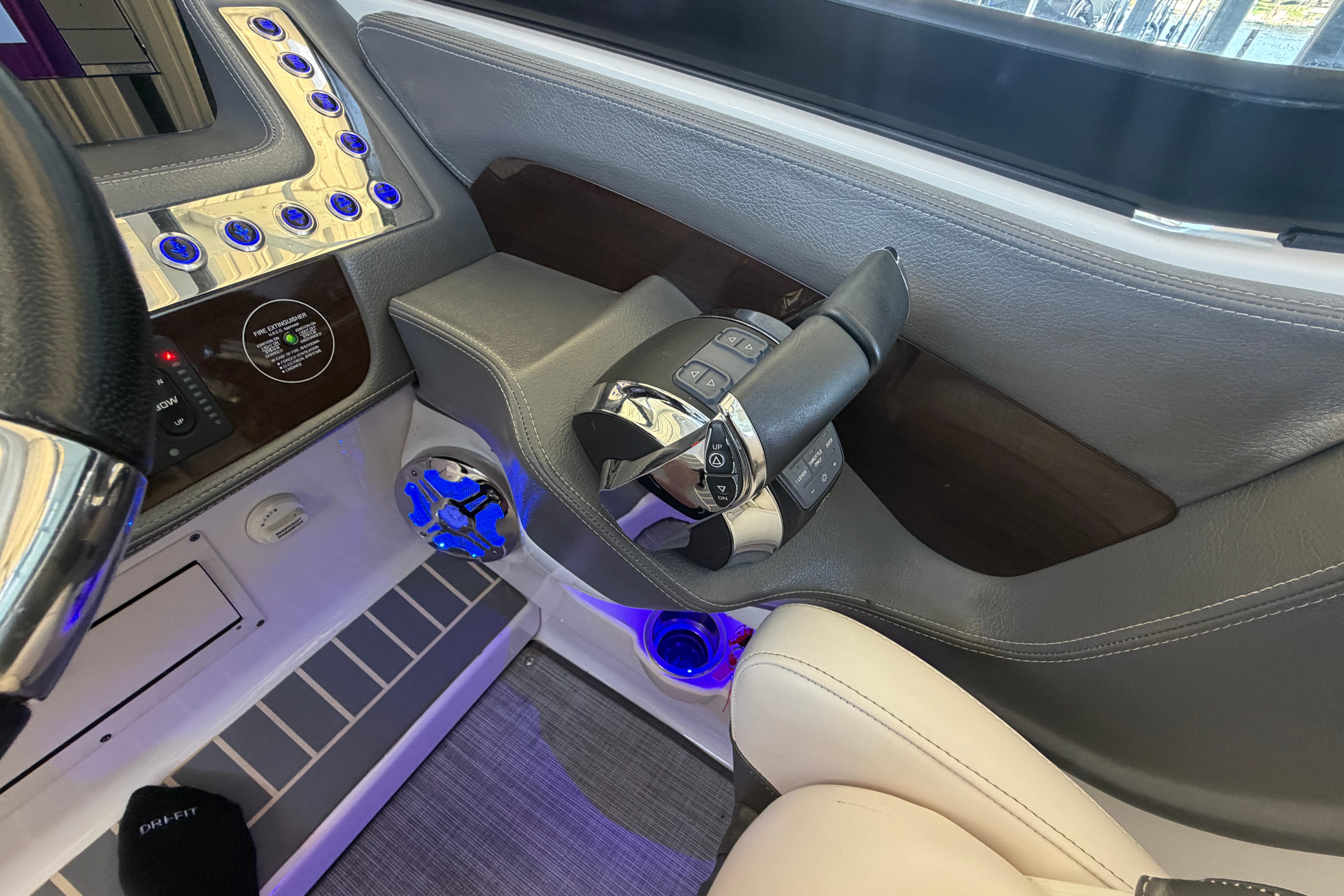 2018 Chaparral 347 SSX boat cockpit with modern controls and illuminated dashboard.