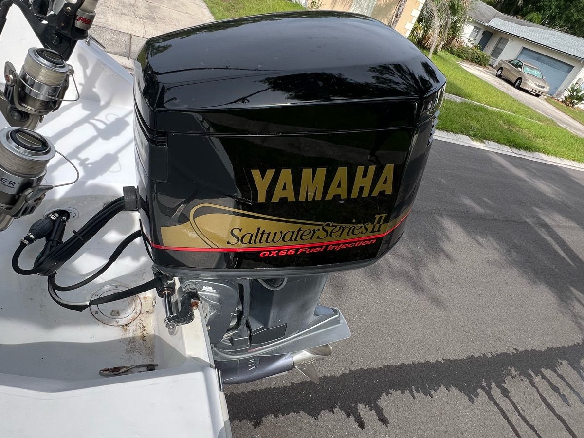A Yamaha outboard motor on a 1994 Sea Ray Laguna boat, parked on a street.