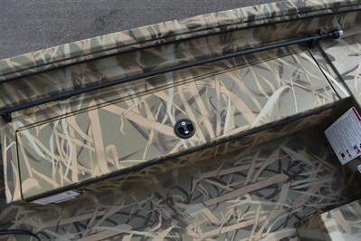 2025 Lowe Roughneck 1860SC boat with camouflage design and storage compartment.