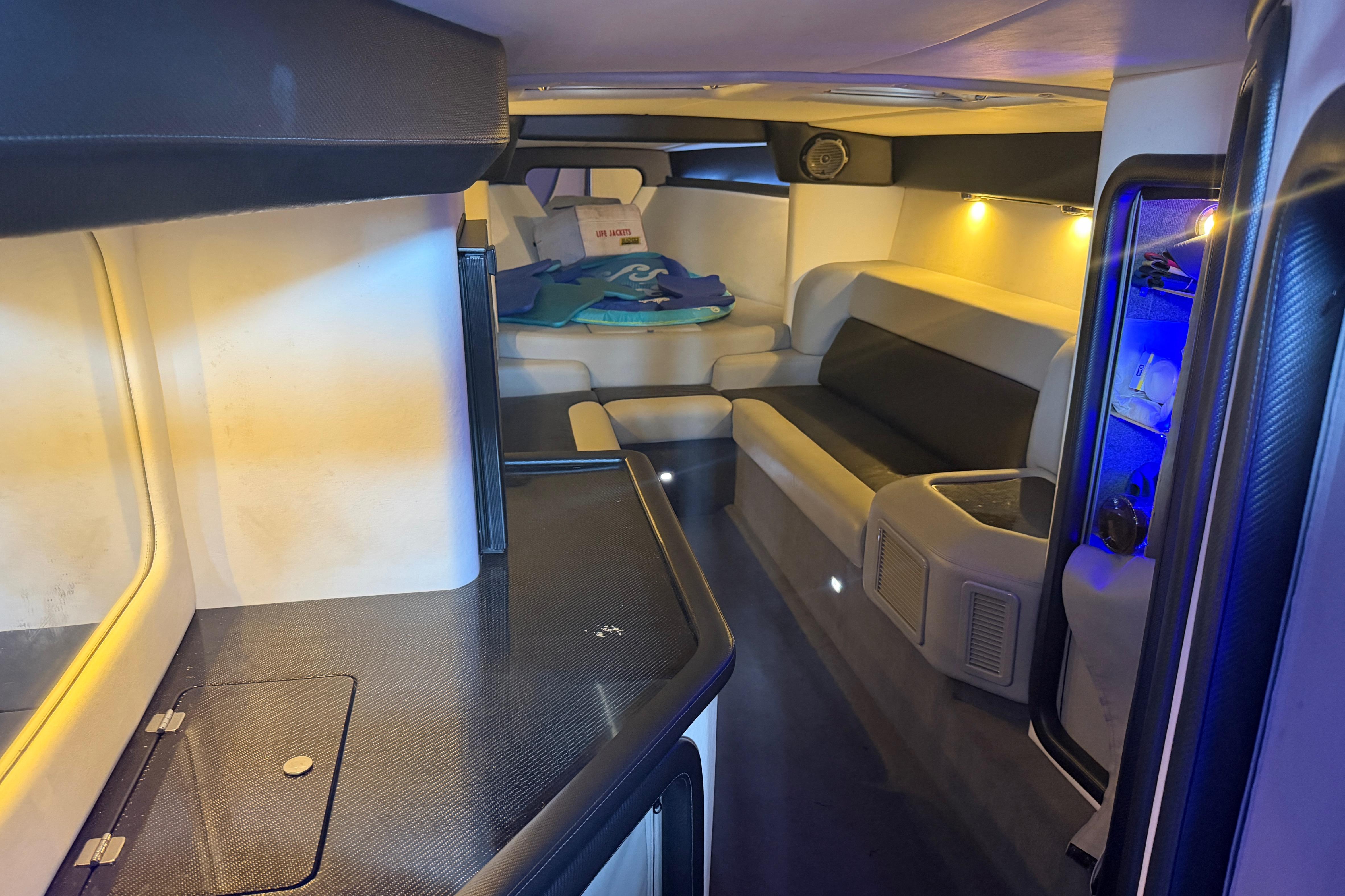 Luxurious interior of a 2013 Nor-Tech 477 SPX Vee Bottom boat with seating and ambient lighting.