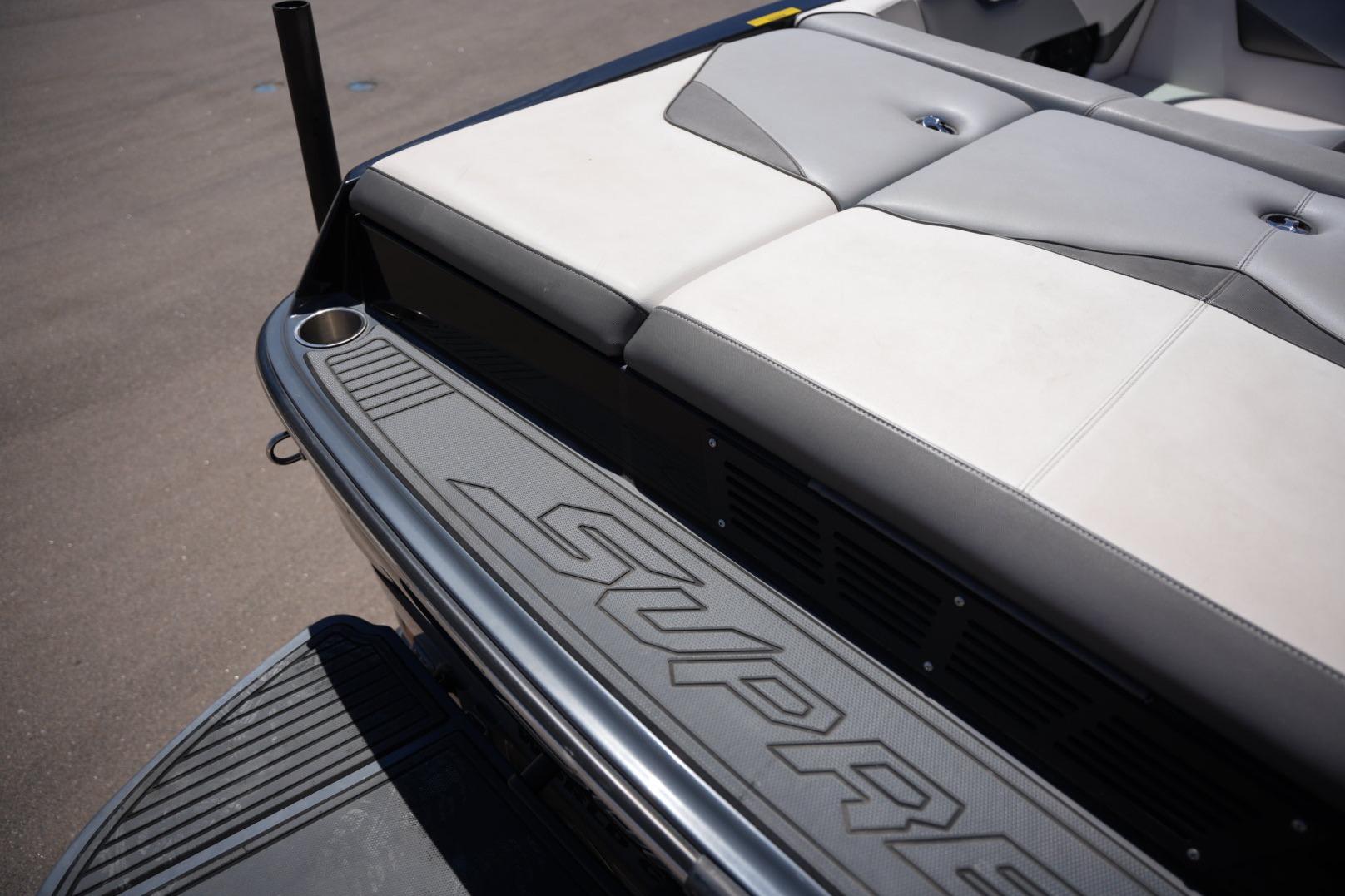 2016 Supreme S211 boat interior with cushioned seating and branded flooring.