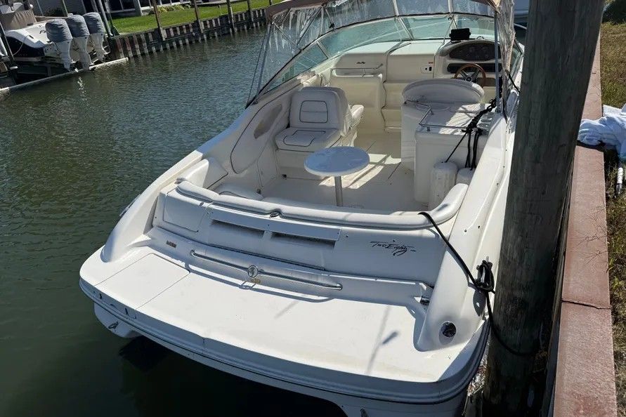 1996 Sea Ray Sun Sport boat docked, featuring white interior.