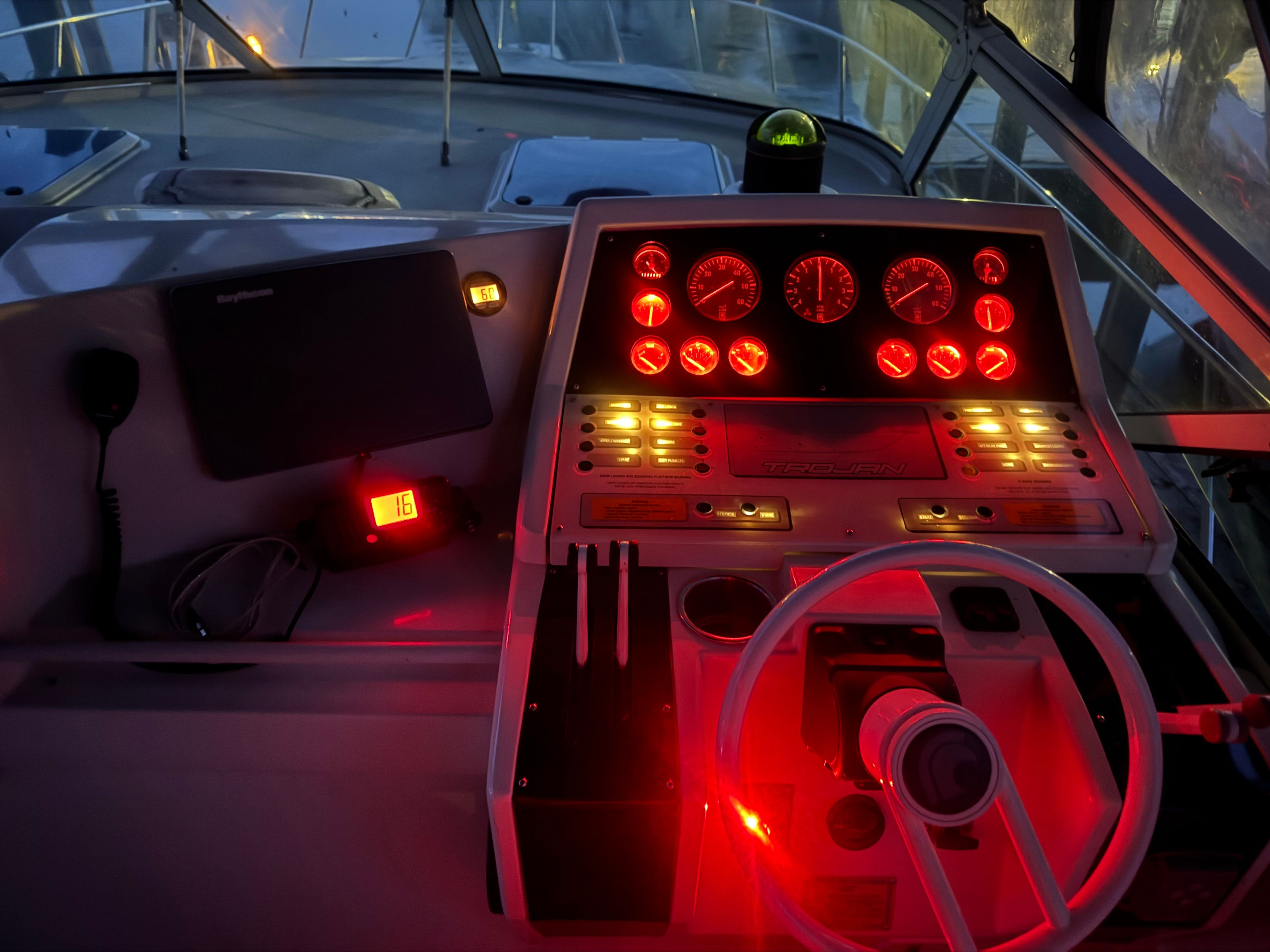 The cockpit of a 1995 Trojan 390x with illuminated instruments and a steering wheel.