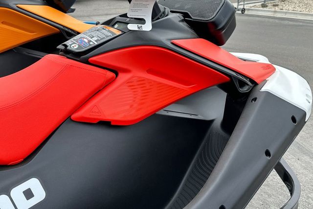 Close-up of a Sea-Doo PWC SPARK TRIXX with red seat and black frame.