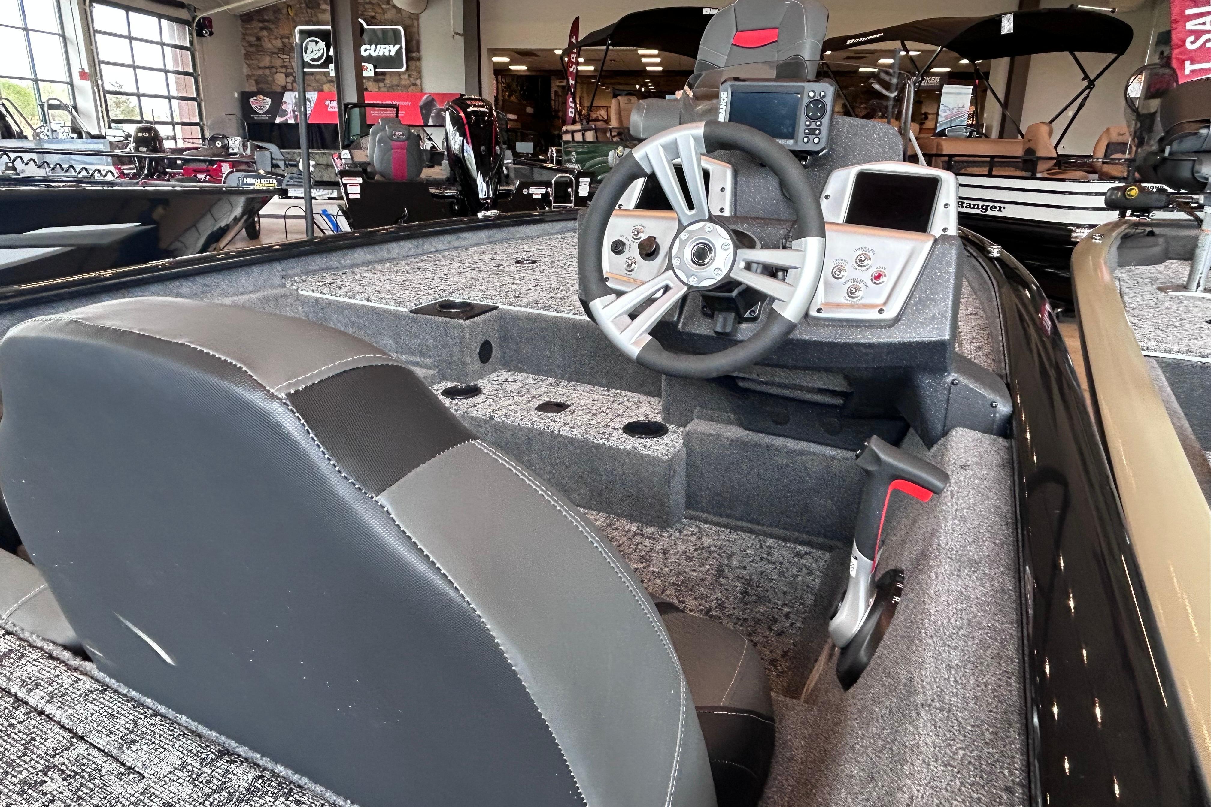 Interior view of 2026 Tracker Pro Team 195 boat, featuring steering wheel and dashboard controls.