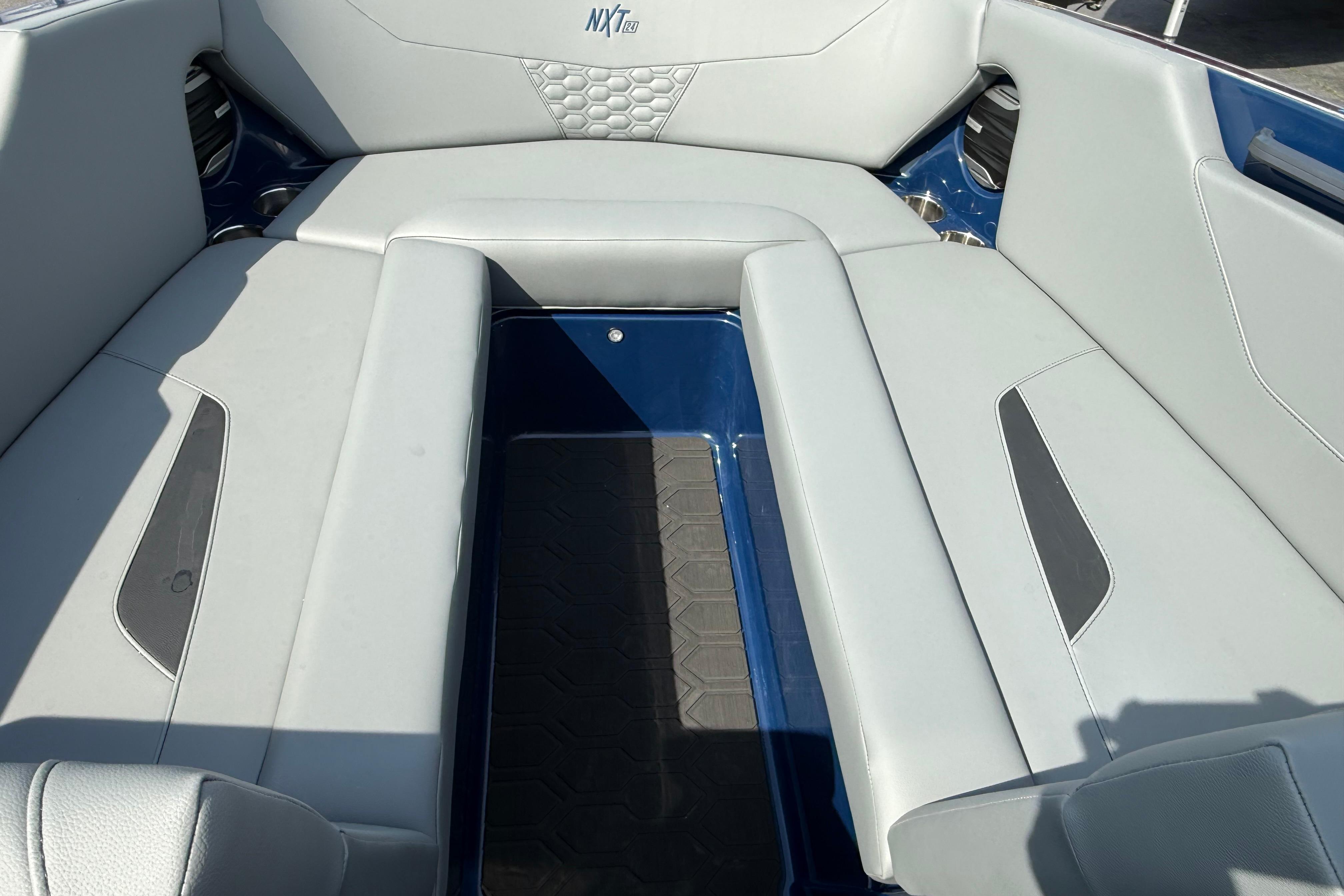 Interior seating of 2026 MasterCraft NXT24 boat, featuring sleek gray upholstery.