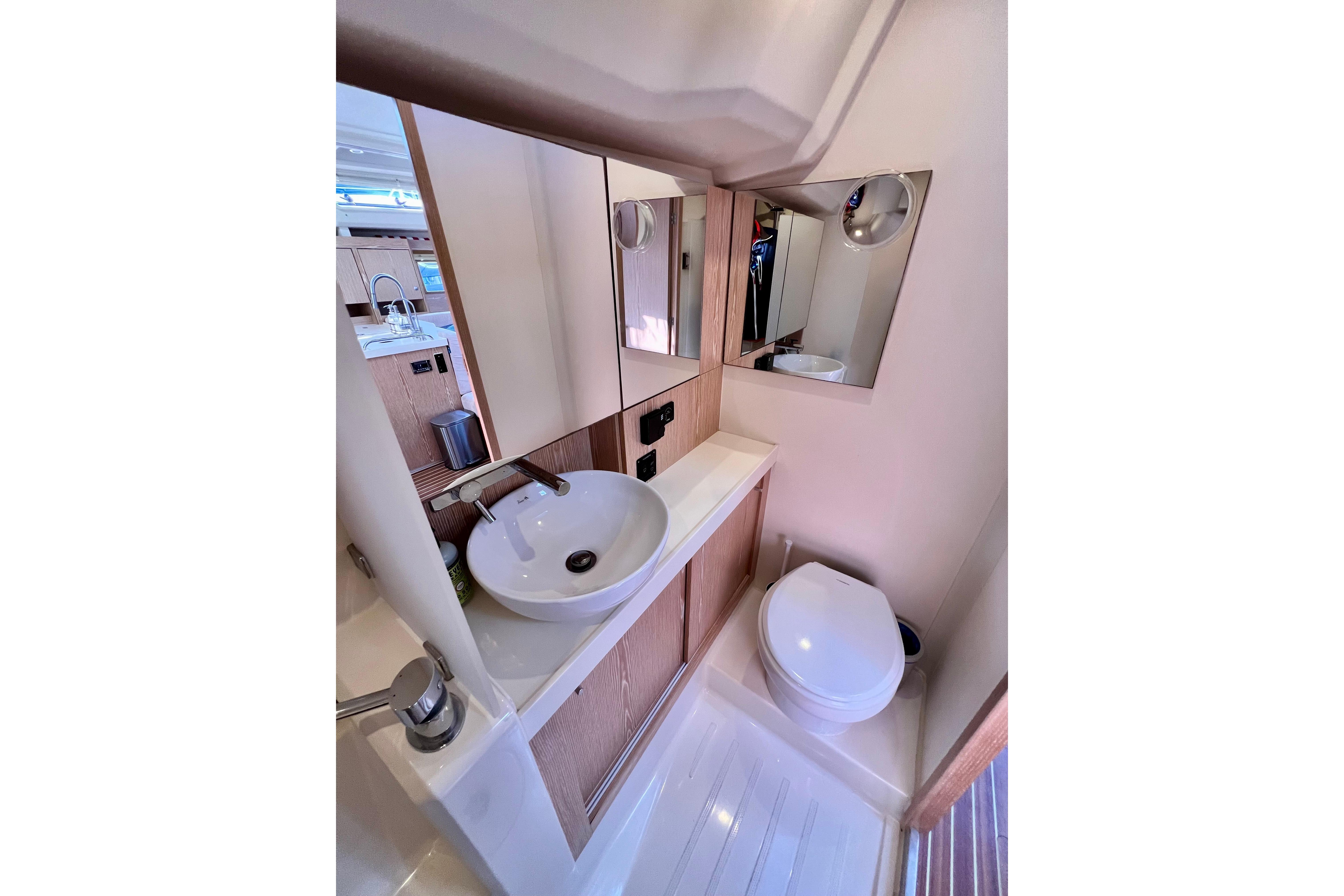 Modern bathroom interior of 2016 Hanse 455 yacht with sink and toilet.