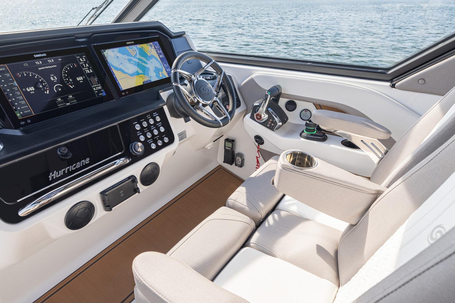 Interior cockpit of 2026 Hurricane SunDeck 3200 OB with advanced navigation displays.