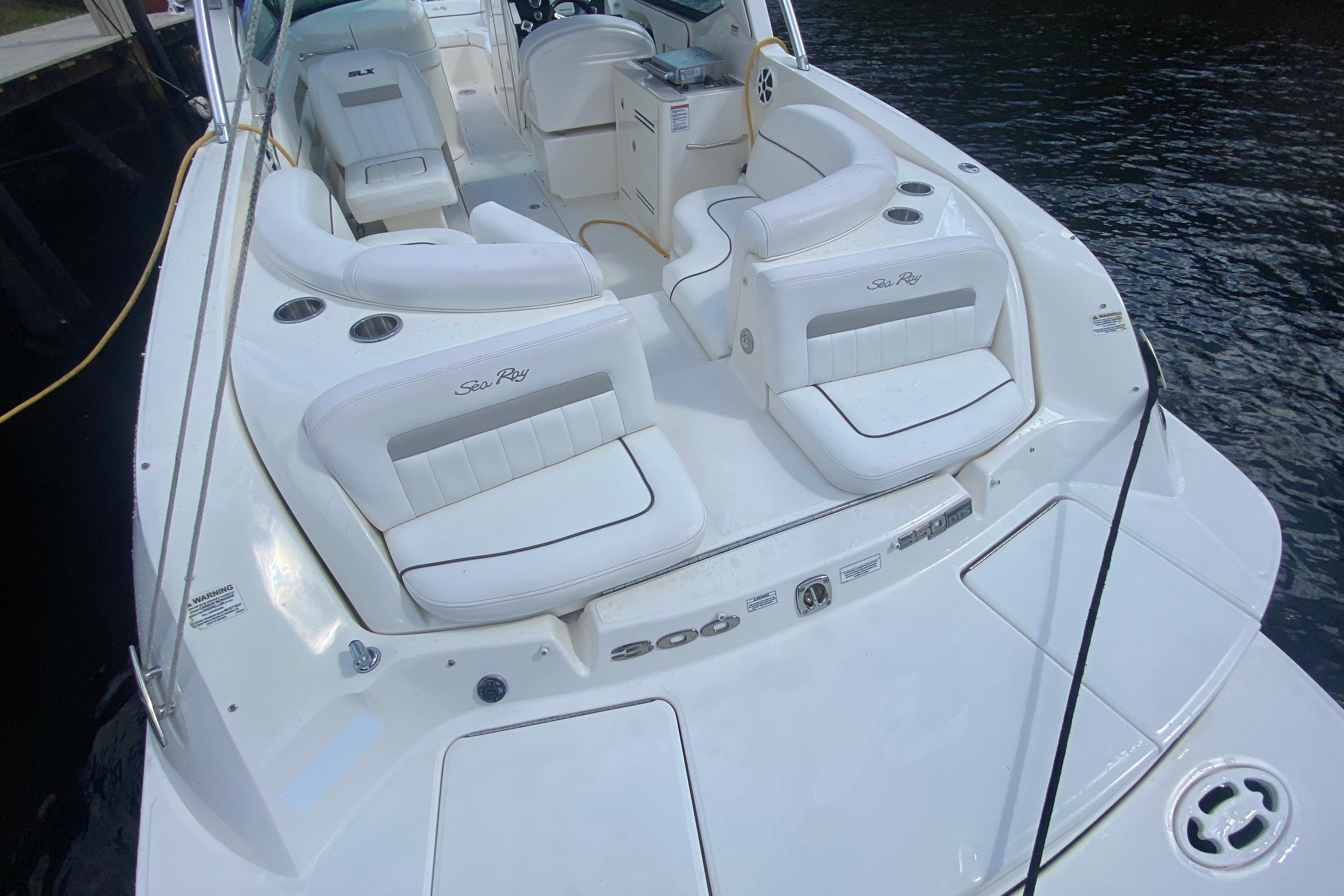 2010 Sea Ray 300 SLX boat with white seating and sleek design on the water.
