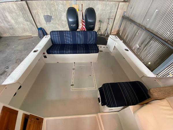 Interior of a 2015 Eastern 27 Islander boat with blue striped seating.