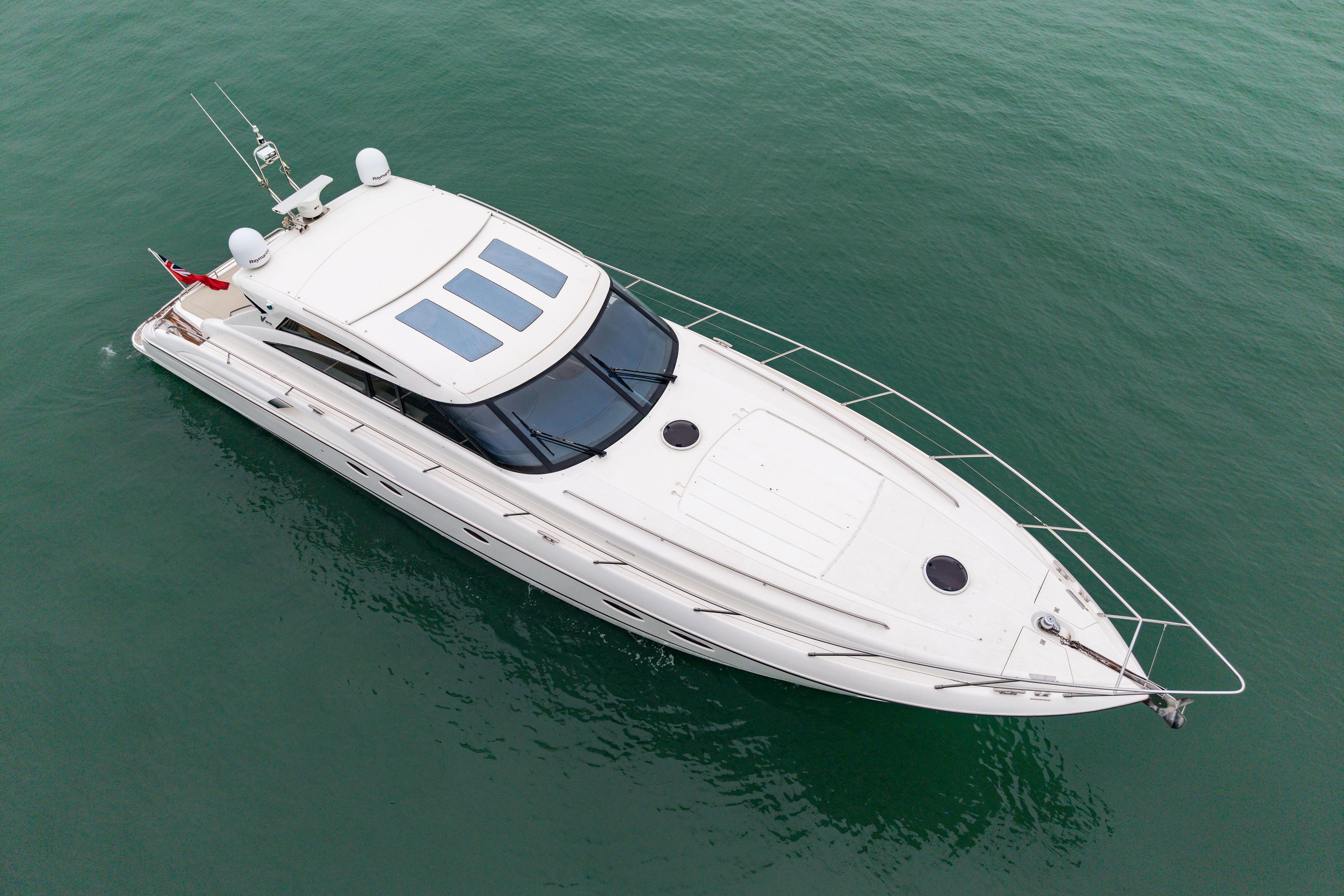 Aerial view of 2009 Princess V58 yacht on calm green water.
