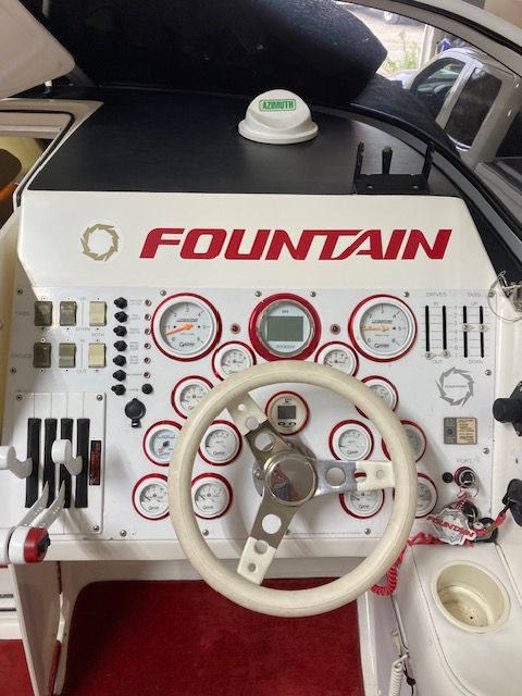 Dashboard of a 2001 Fountain Lightning boat with steering wheel and gauges.