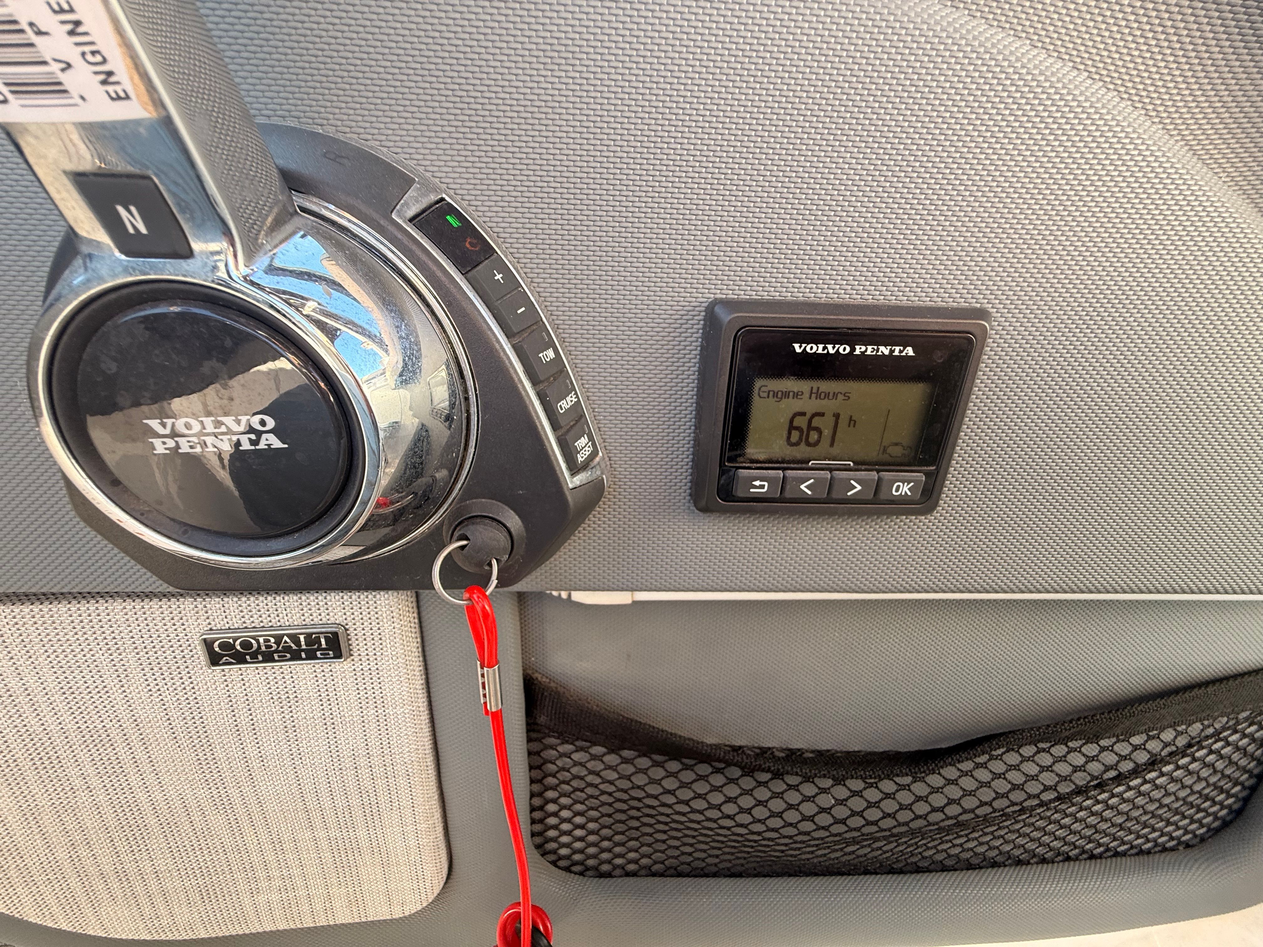 Close-up of a boat panel with Volvo Penta controls and engine hour meter.