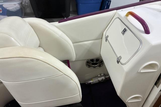 1984 Cigarette 35' Cafe Racer interior with white seating and storage compartment.