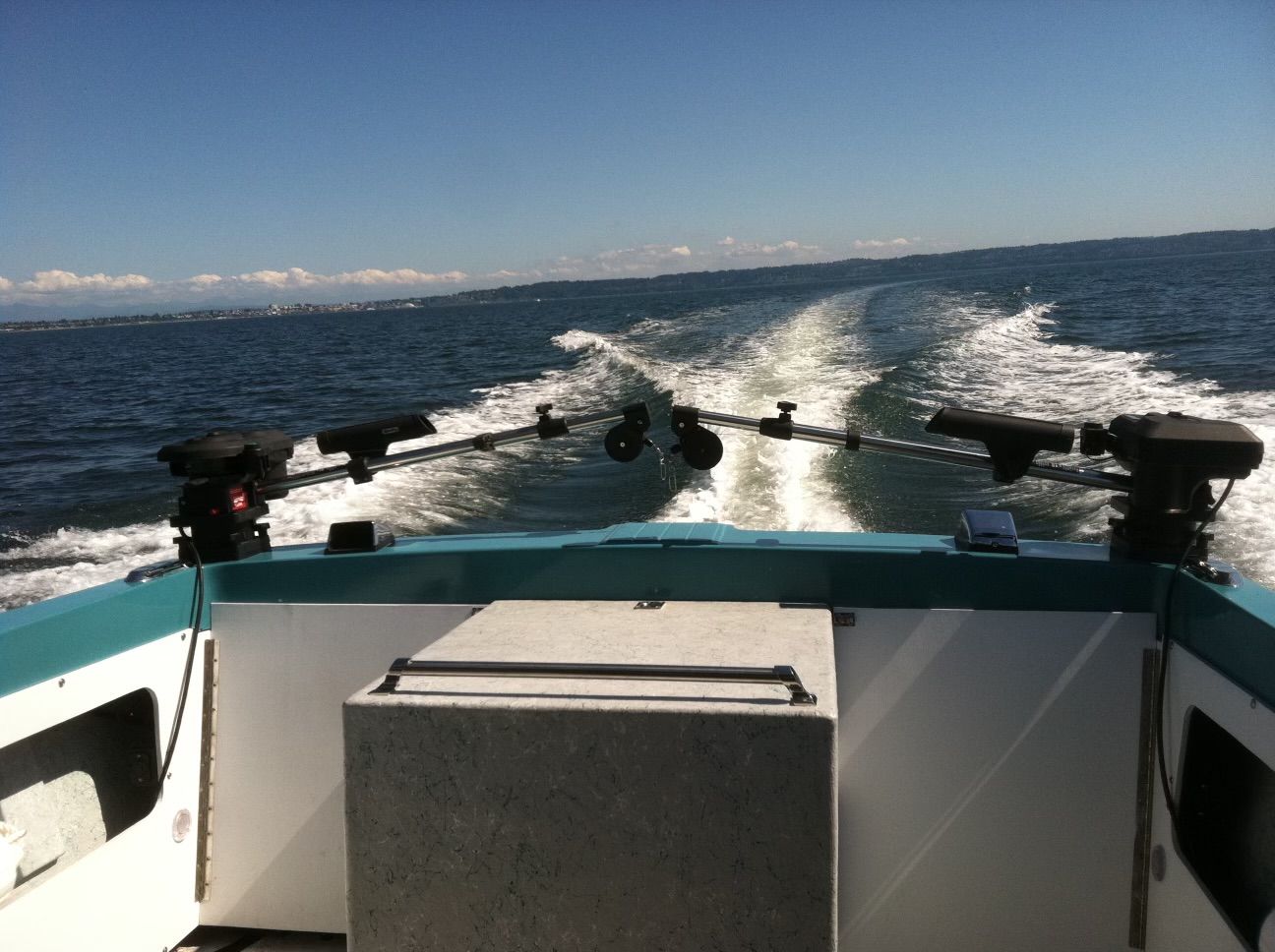 View from the stern of a restored Fiberform boat looking out to open sea.