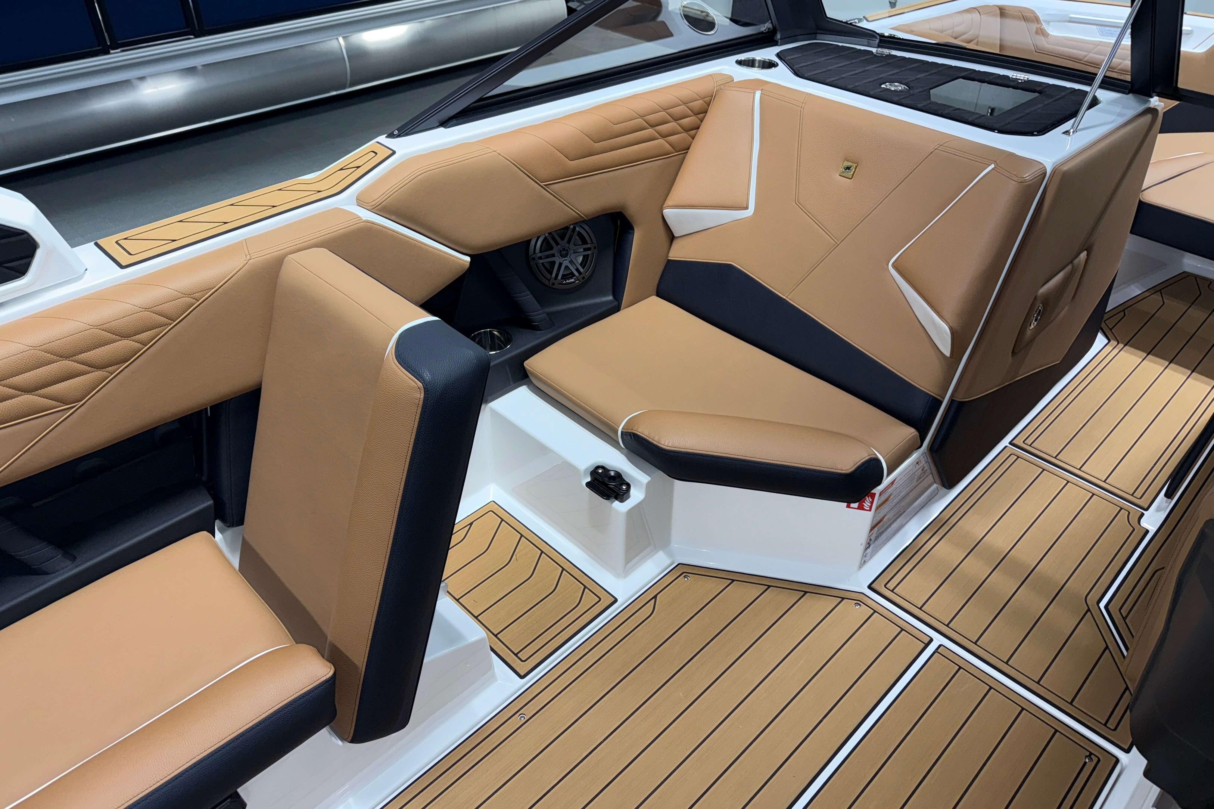 2026 Nautique Super Air Nautique S23 interior with tan and black seating, stylish design.